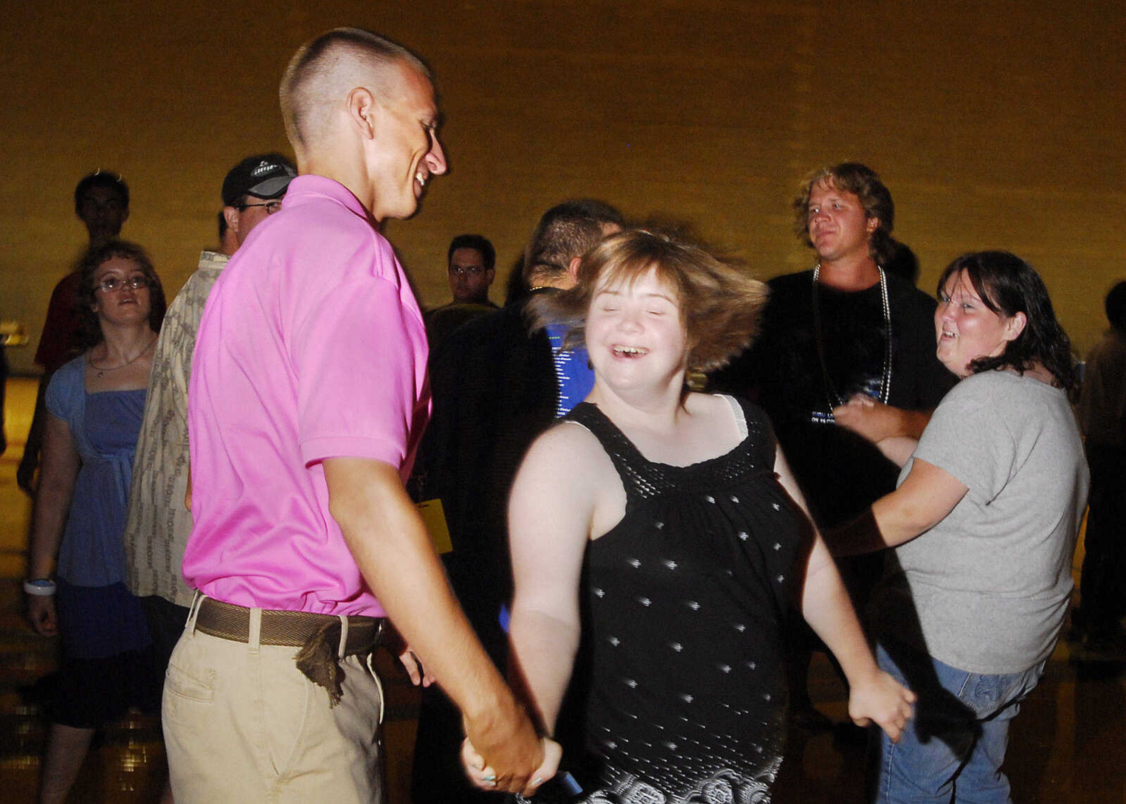 LAURA SIMON~lsimon@semissourian.com
Special Olympic unified partner Josh Buchheit twirls athlete Lindsey Hawkins Saturday, August 14, 2010 during the Special Olympics dance at Southeast Missouri State University's student Rec Center.