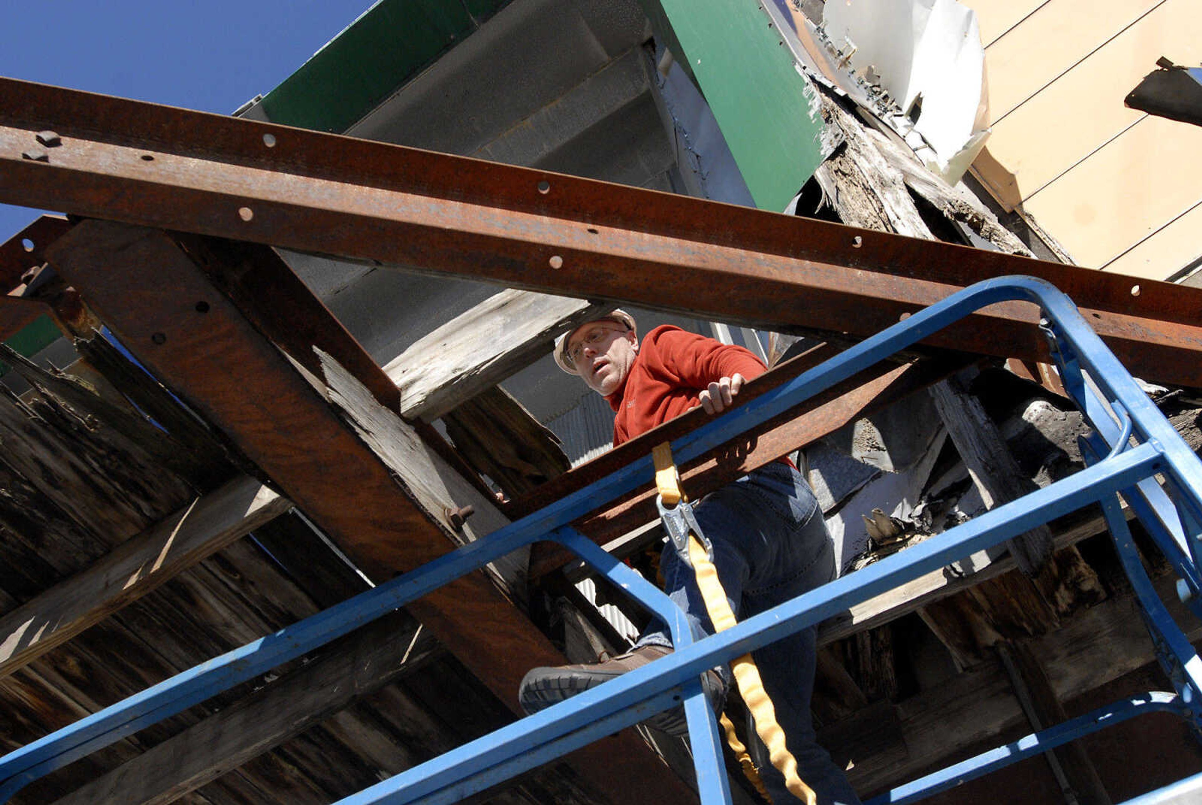 KRISTIN EBERTS ~ keberts@semissourian.com

Dennis Hyland, of Kiku Obata & Company, works to take measurements of the front facade of the Esquire Theater building on Friday, Jan. 6, 2012, in Cape Girardeau. Renovation work on the Esquire Theater continues as workers from Kiku Obata & Company and Penzel Construction complete field verification work and take measurements necessary for the design plans.