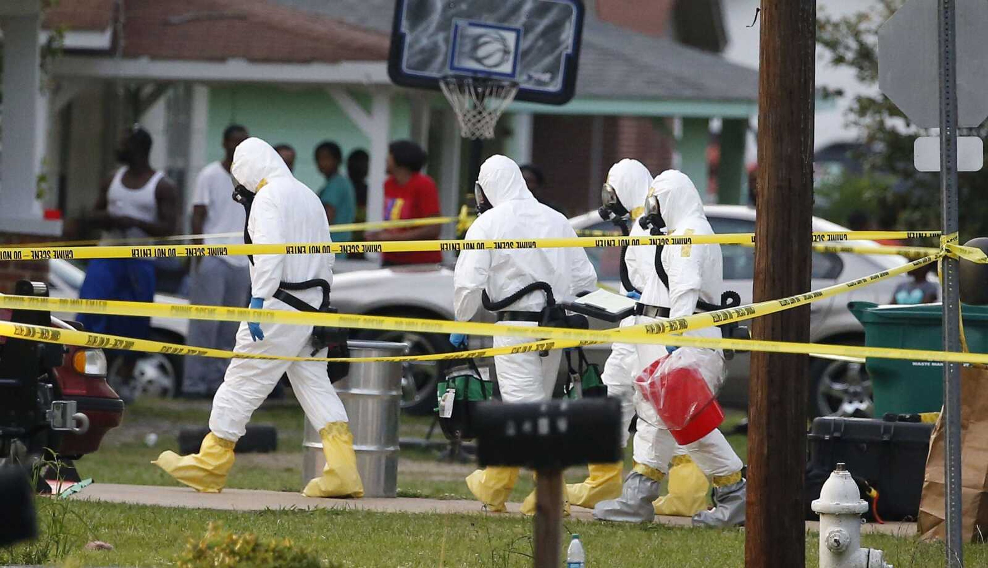 Federal authorities wearing hazmat suits walk to the home of Everett Dutschke for additional investigation, Tuesday evening, April 23, 2013 in Tupelo, Miss., in connection with the recent ricin attacks. No charges have been filed against Dutschke and he hasn&#237;t been arrested. (AP Photo/Rogelio V. Solis)