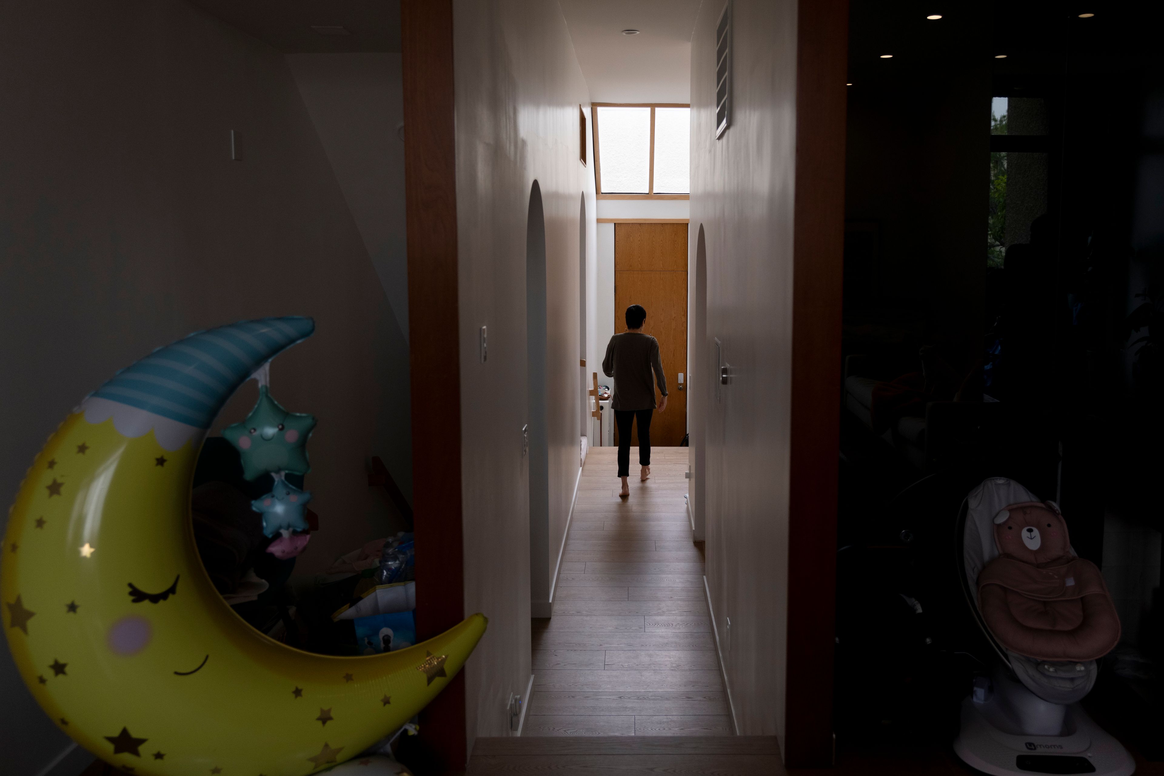 Robyn Joy Park, an adoptee from South Korea, walks through her home after the birth of her first child, in Pasadena, Calif., Friday, April 19, 2024. (AP Photo/Jae C. Hong)