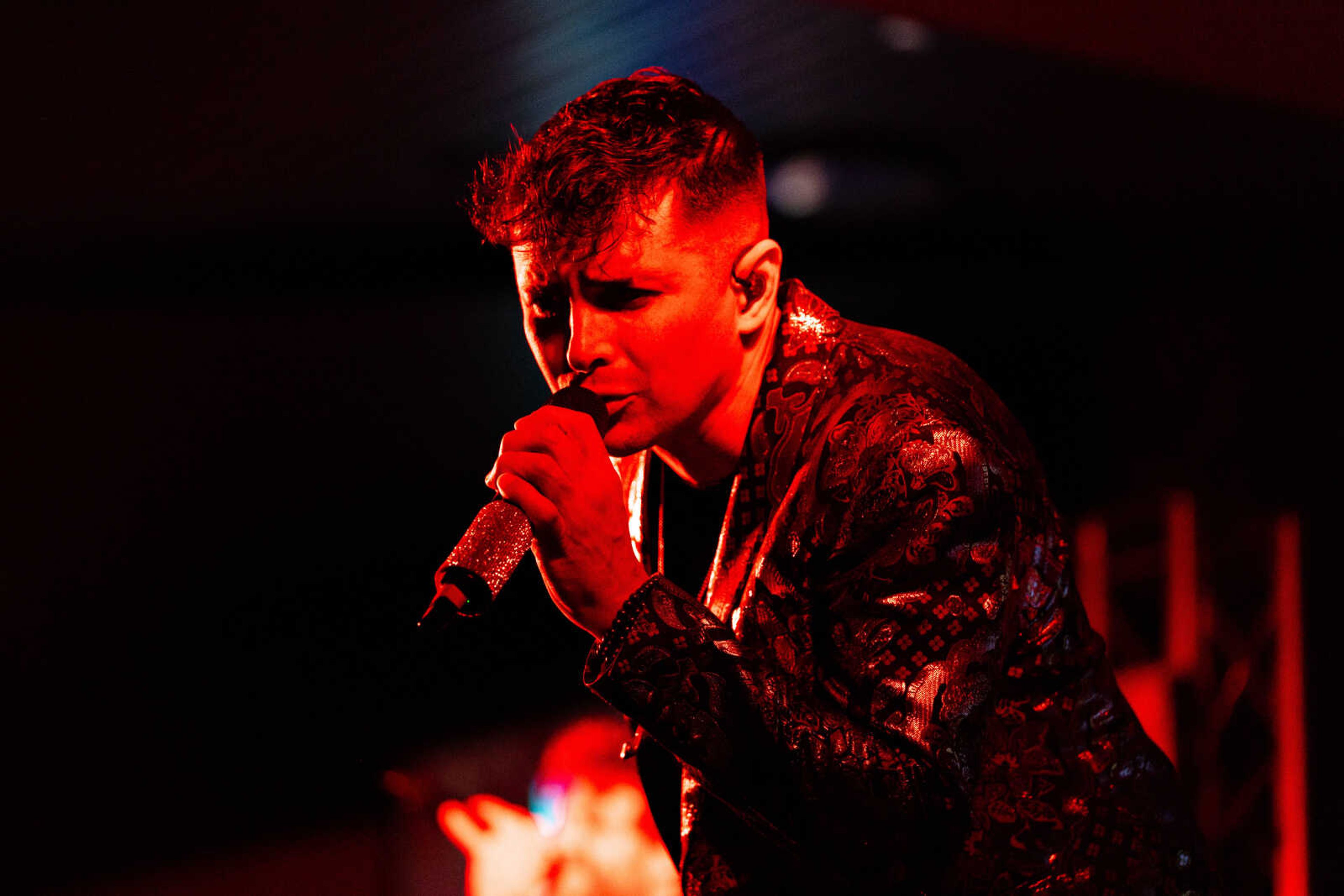 One of the singers from the 12 South Band plays to the crowd on the dance floor at the Drury Conference Center.