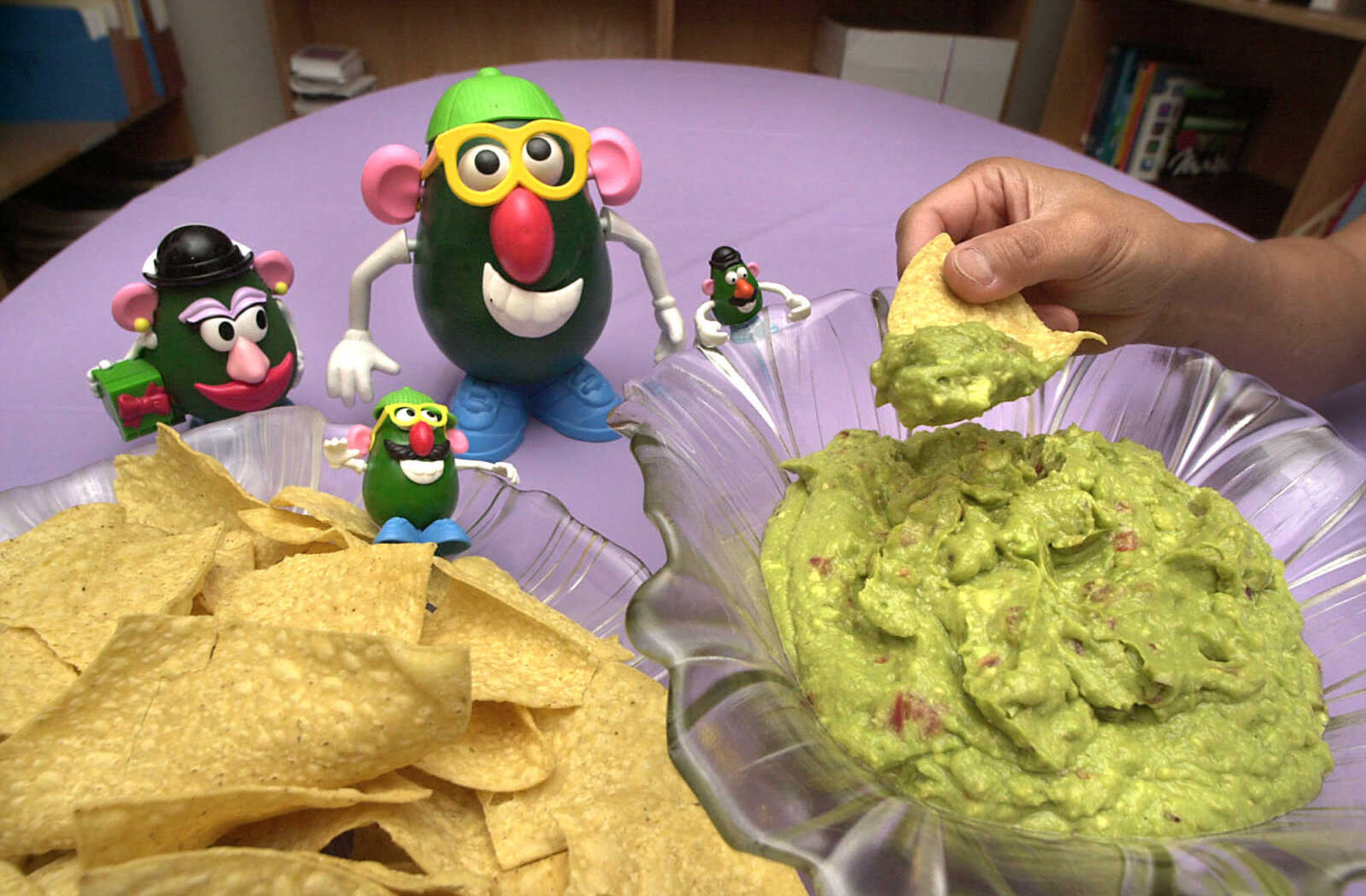 The Avocado family stood ready in Tom Harte's kitchen to savor their favorite Cinco de Mayo treat: guacamole. It's one way that more avocados are consumed on May 5 than any other day. April 6, 2002. (Fred Lynch)