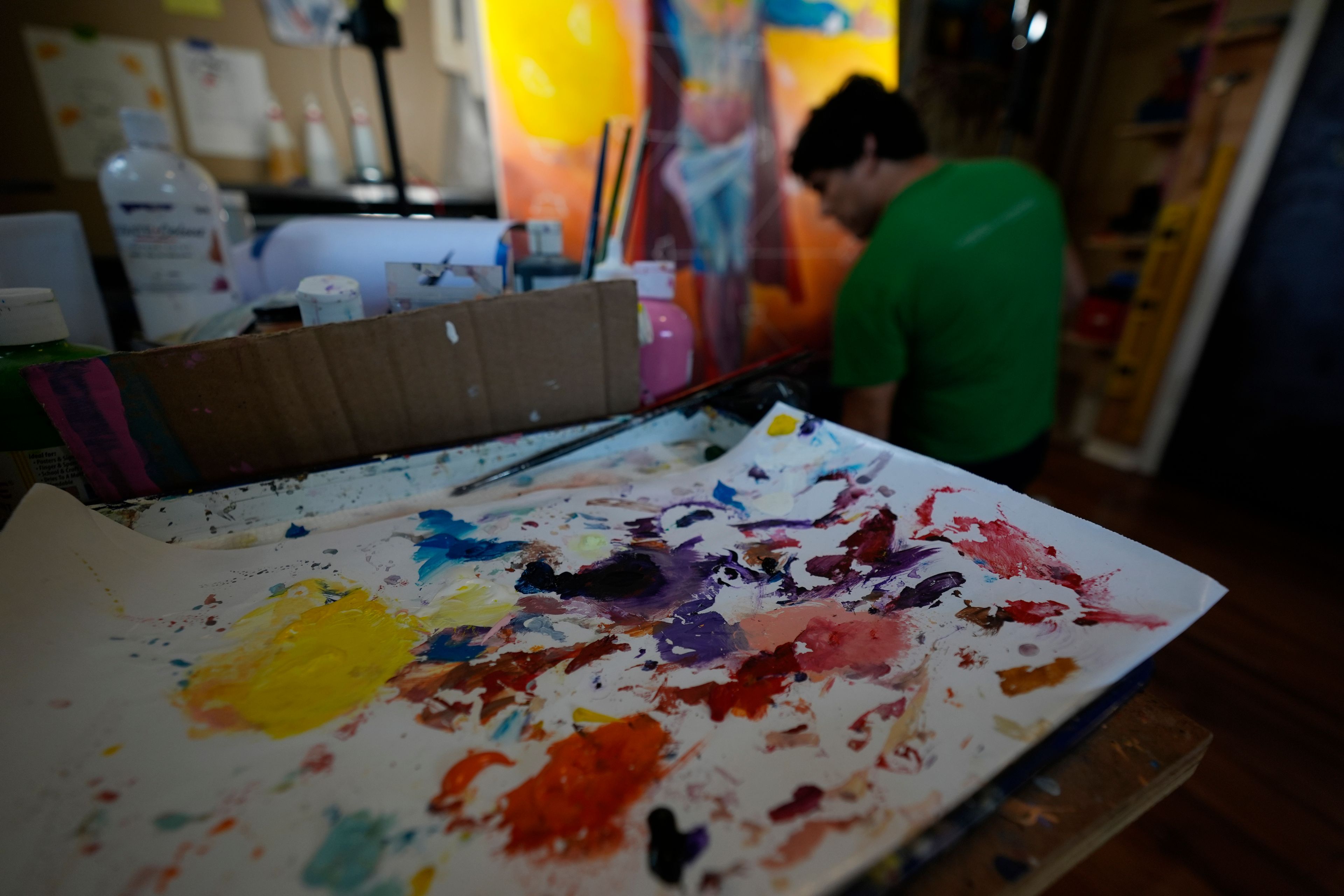 Artist David Alcantar works on an art piece for his "Superman Project" that in part encourages people to exercise their right to vote in San Antonio, Thursday, Sept. 19, 2024. (AP Photo/Eric Gay)