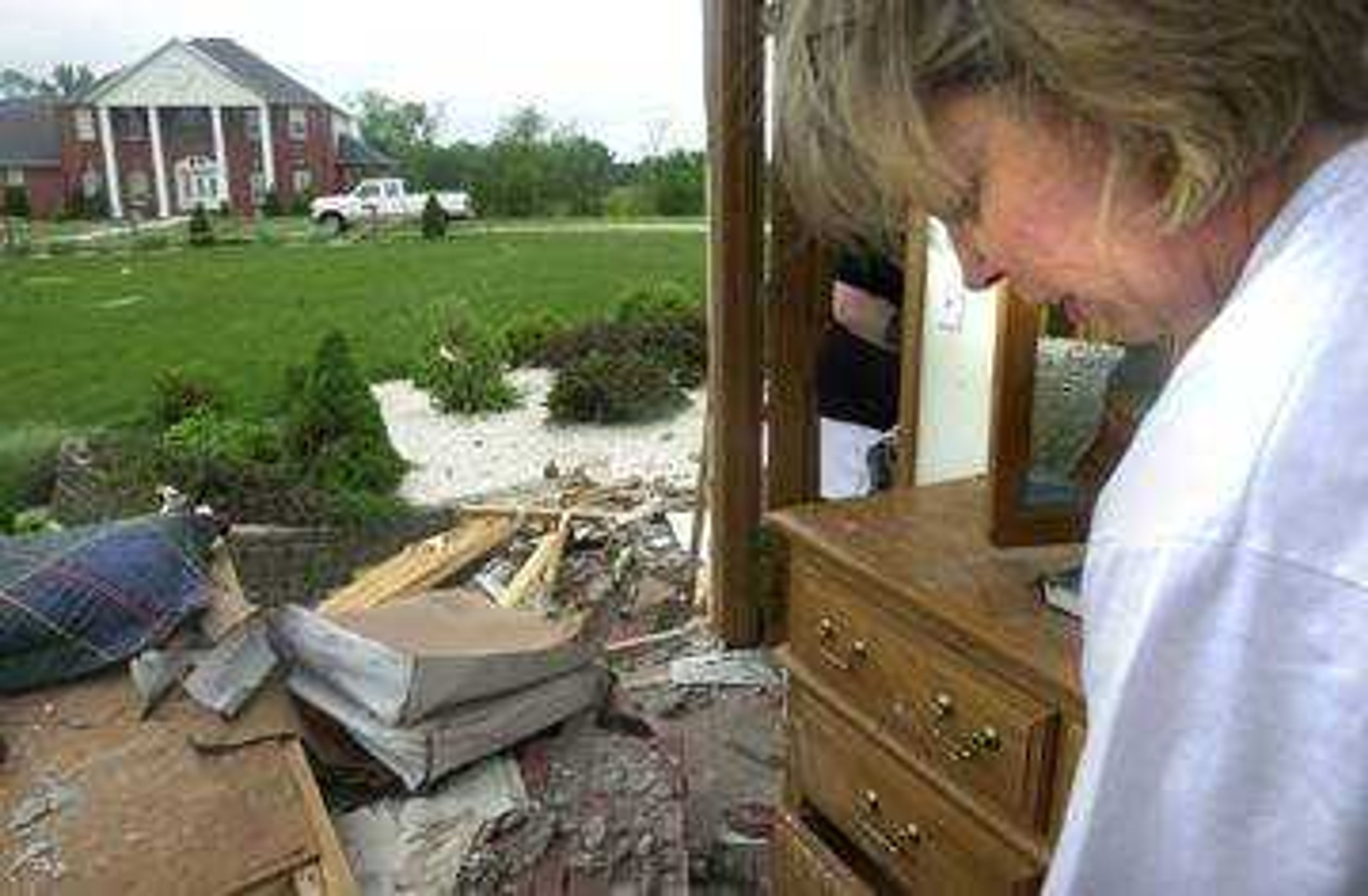 Diana Fox of St Louis came down to Jackson, Mo., to help sister Judy Harrison clear debris from her house on St Andrews Drive.  Fox stood in the spare bedroom where  daughter Courtney would have slept the night of the tornado.