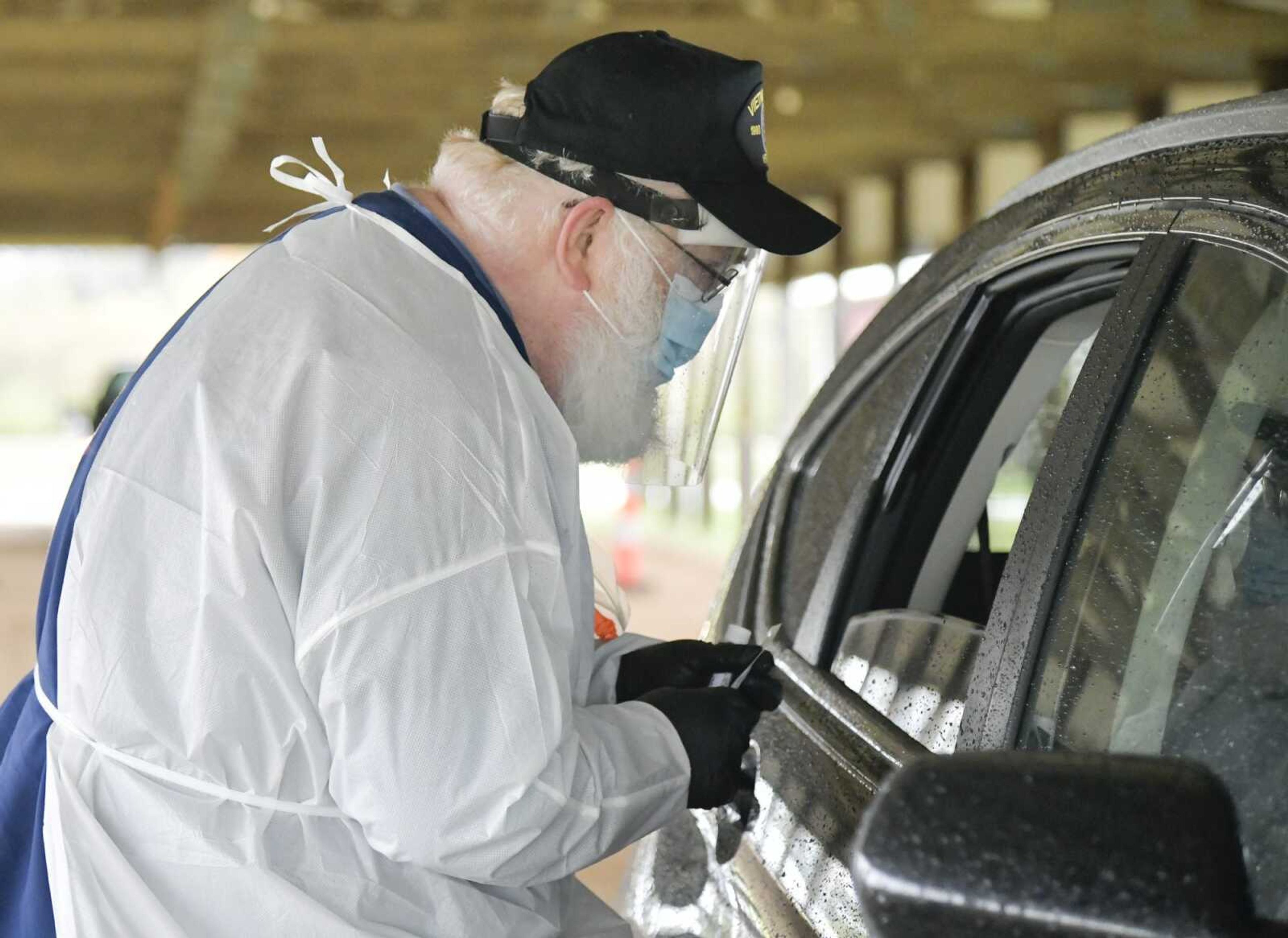 Nurse Fred Kapelski talks to a person about to be tested in their car during the Cape Girardeau County Public Health Center free COVID-19 testing Oct. 29 at Arena Park in Cape Girardeau.