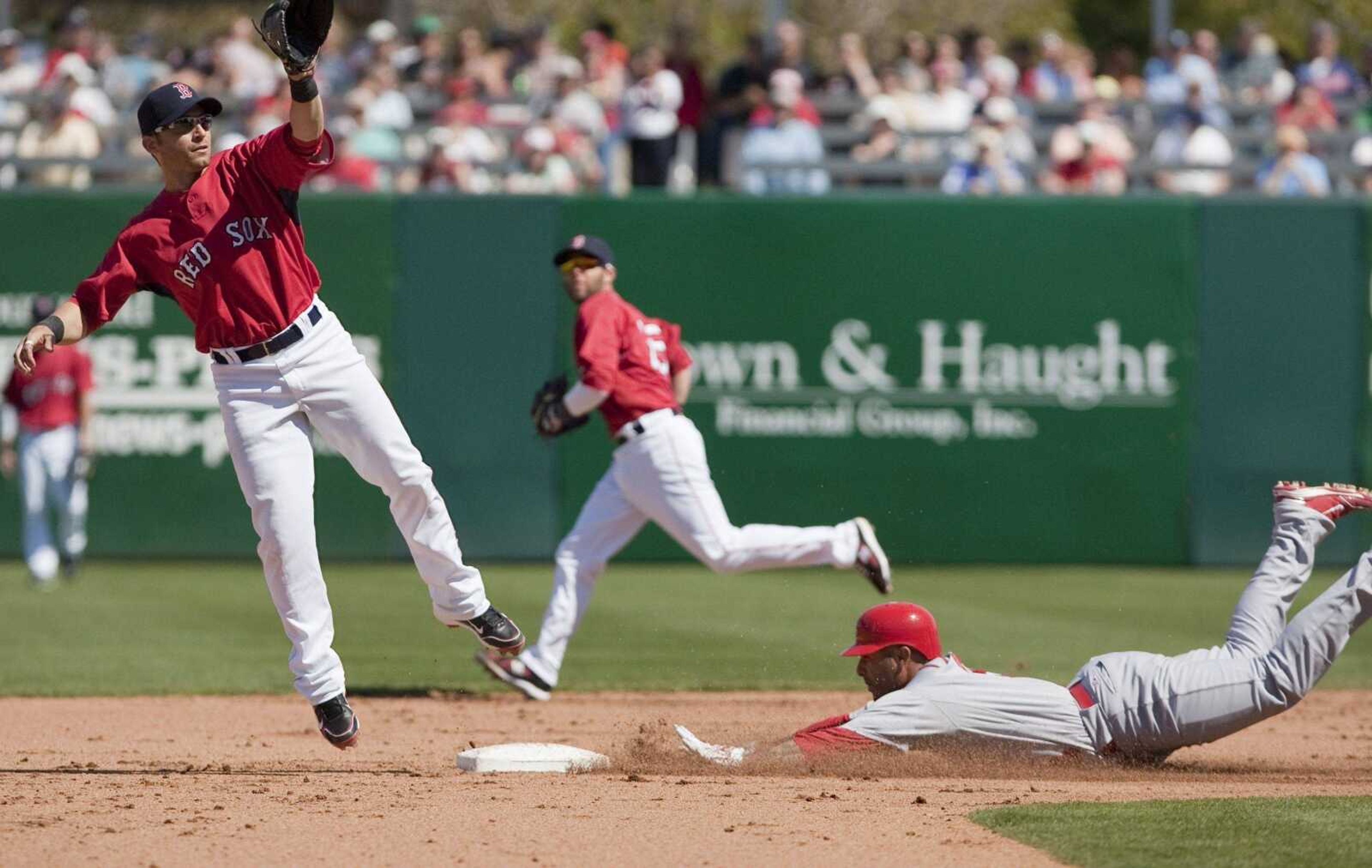 Saint Louis Cardinals Felipe Lopez, right, steals second base against Boston Red Sox short stop Marco Scutaro, in the fourth inning of a spring training baseball game in Fort Myers, Fla., Monday, March 8, 2010.(AP Photo/Nati Harnik)