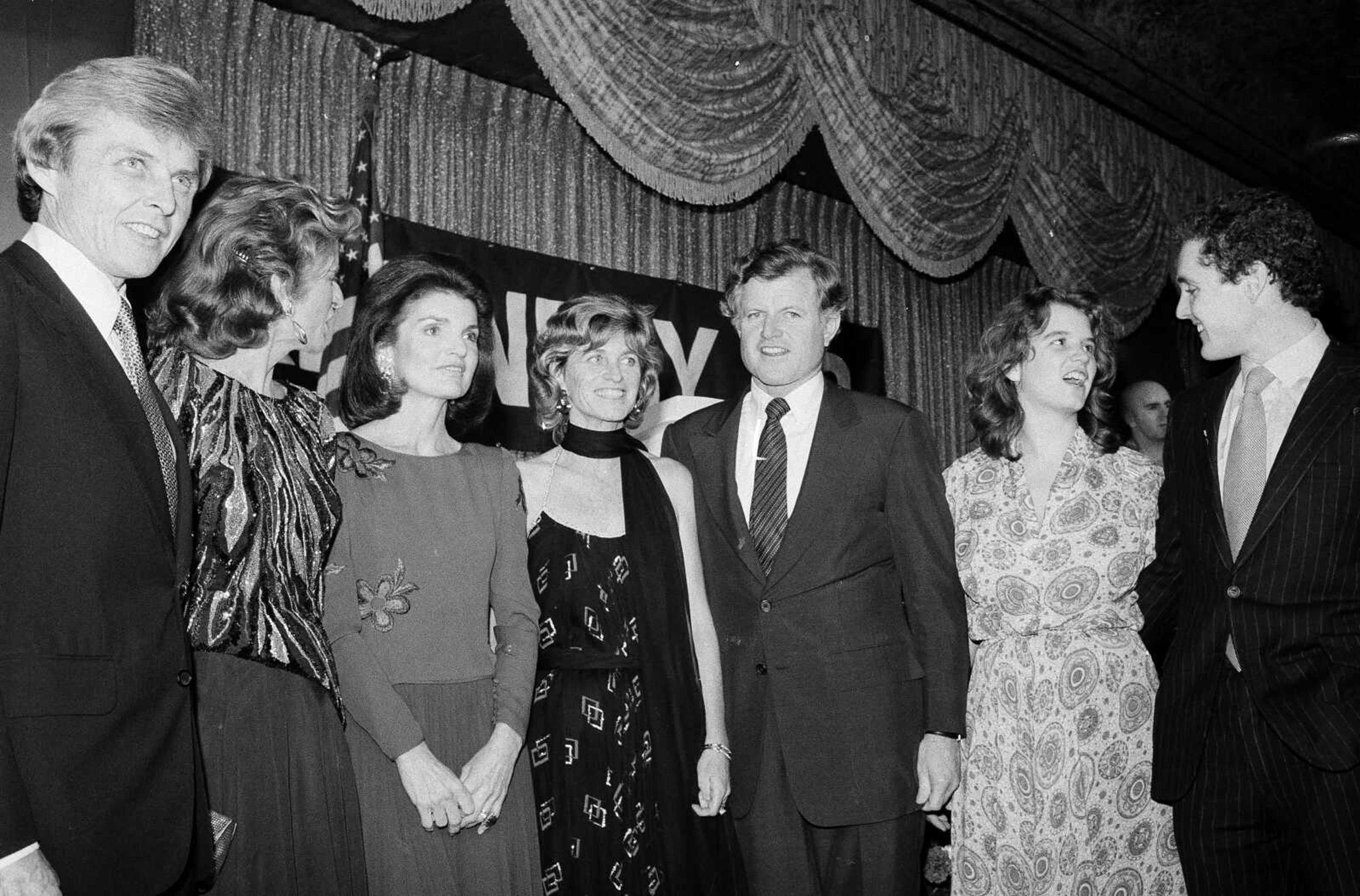 Members of the Kennedy family pose at a fundraising dinner Dec. 12, 1979, at the Hotel Pierre in New York. From left: Steve Smith; Pat Lawford; Jackie Onassis; Jean Kennedy Smith; Sen. Edward M. Kennedy (D-Mass.); Kerry Kennedy, daughter of the late Robert F. Kennedy; and Steve Smith Jr.  Jean Kennedy Smith, the youngest sister and last surviving sibling of President John F. Kennedy, died at 92, her daughter confirmed to The New York Times on Wednesday.