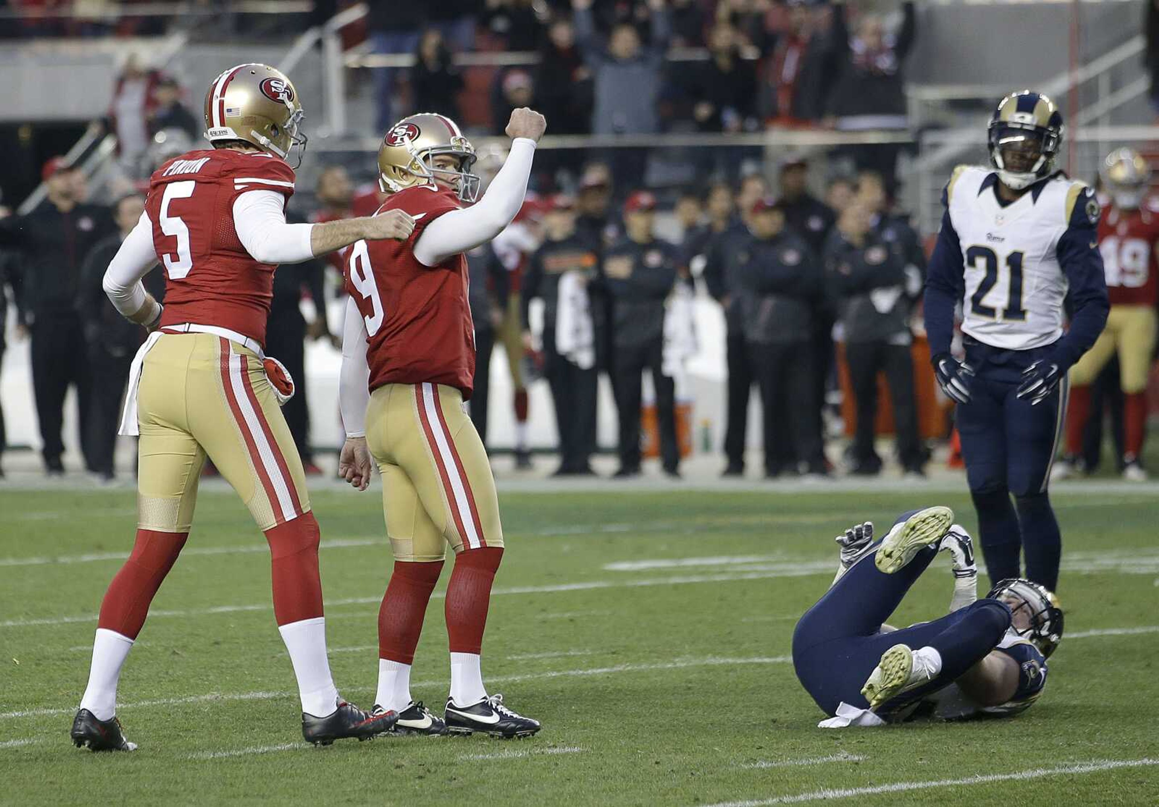 49ers kicker Phil Dawson (9) celebrates with Bradley Pinion after kicking the game-winning field goal in overtime in front of the Rams' Cody Davis and Janoris Jenkins (21) on Sunday in Santa Clara, California. The 49ers won 19-16. (Marcio Jose Sanchez ~ Associated Press)