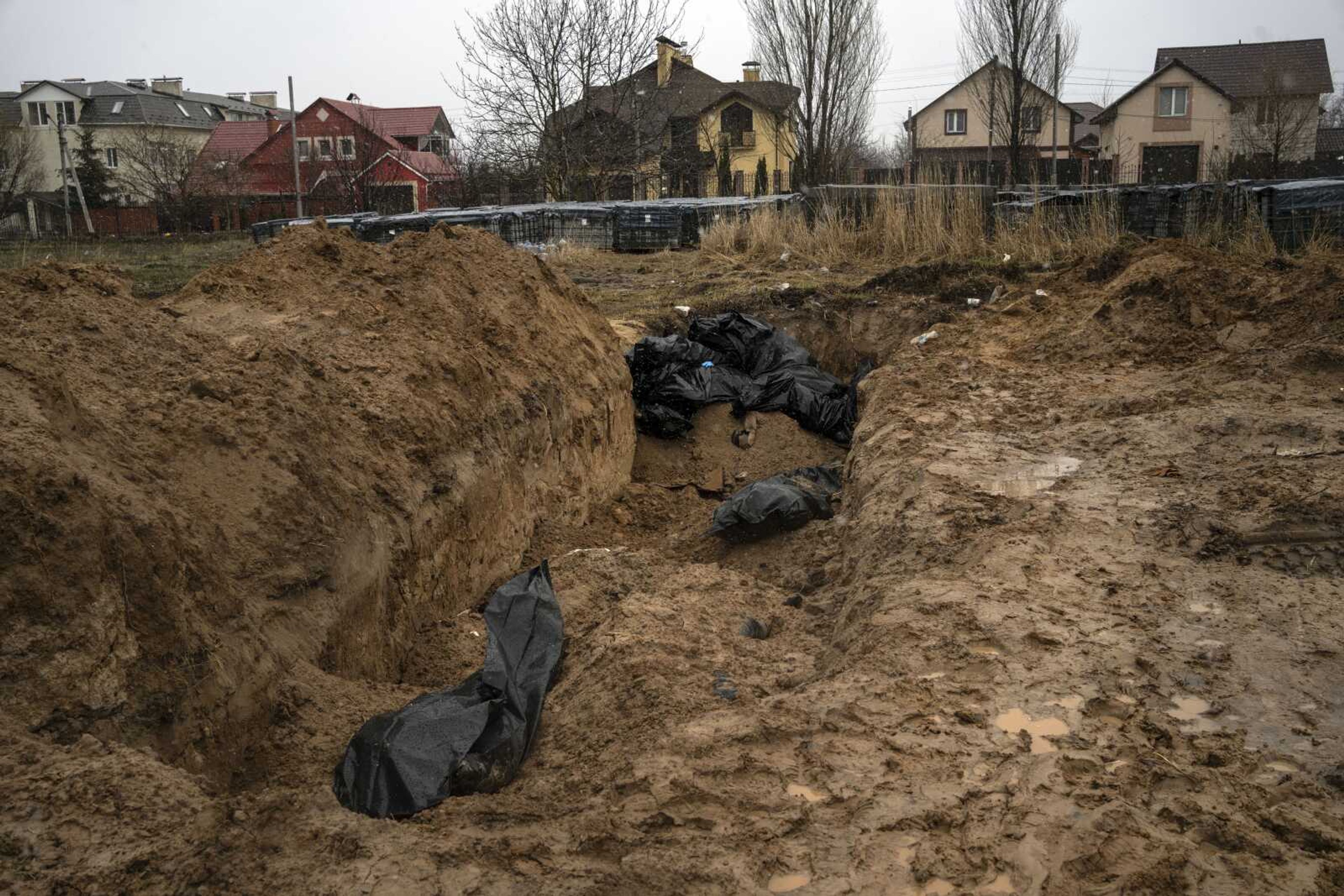 A mass grave Sunday in Bucha, on the outskirts of Kyiv, Ukraine. Ukrainian troops are finding brutalized bodies and widespread destruction in the suburbs of Kyiv, sparking new calls for a war crimes investigation and sanctions against Russia.