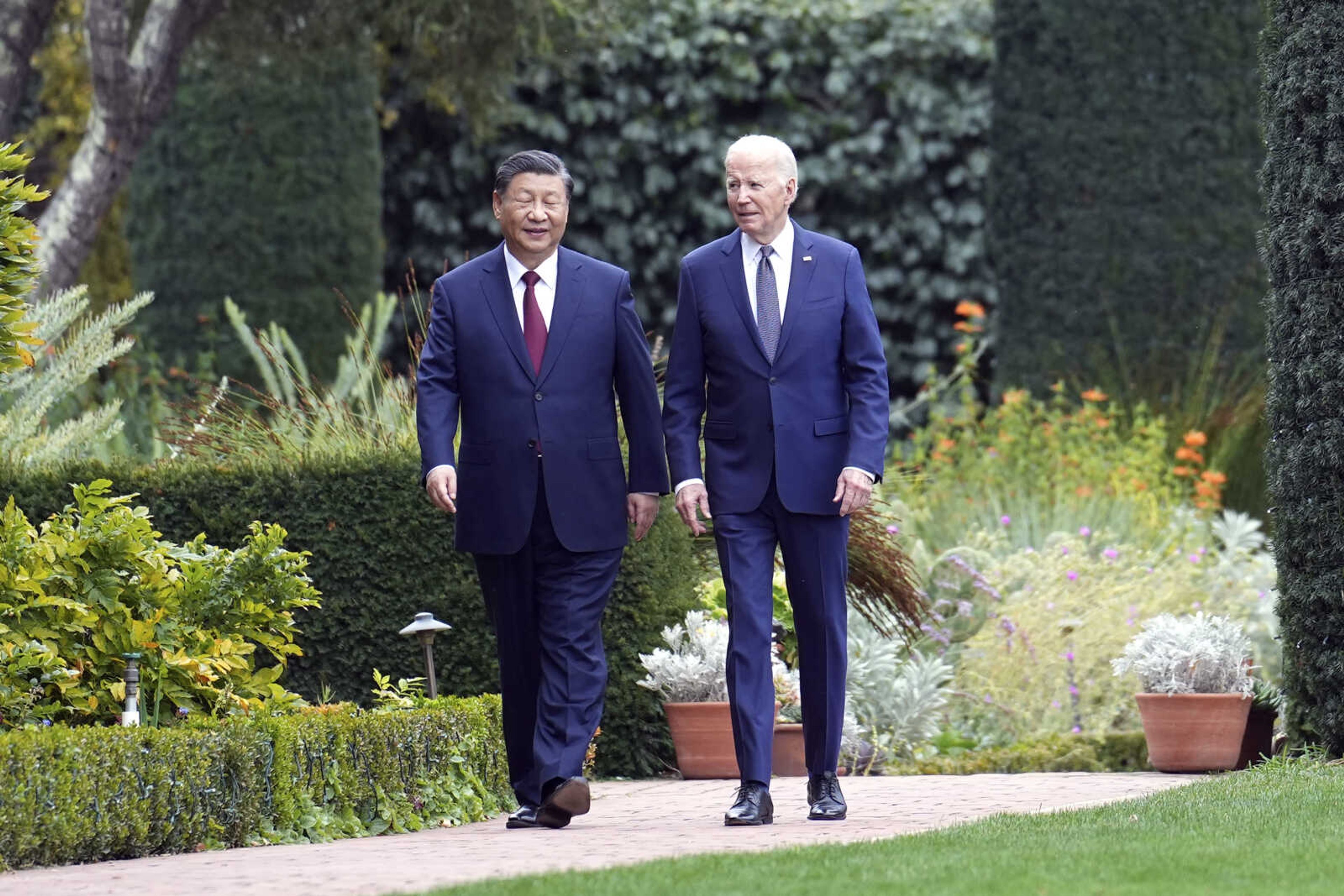 President Joe Biden and China's President Xi Jinping walk in the gardens at the Filoli Estate on Wednesday in Woodside, California, on the sidelines of the Asia-Pacific Economic Cooperative conference.