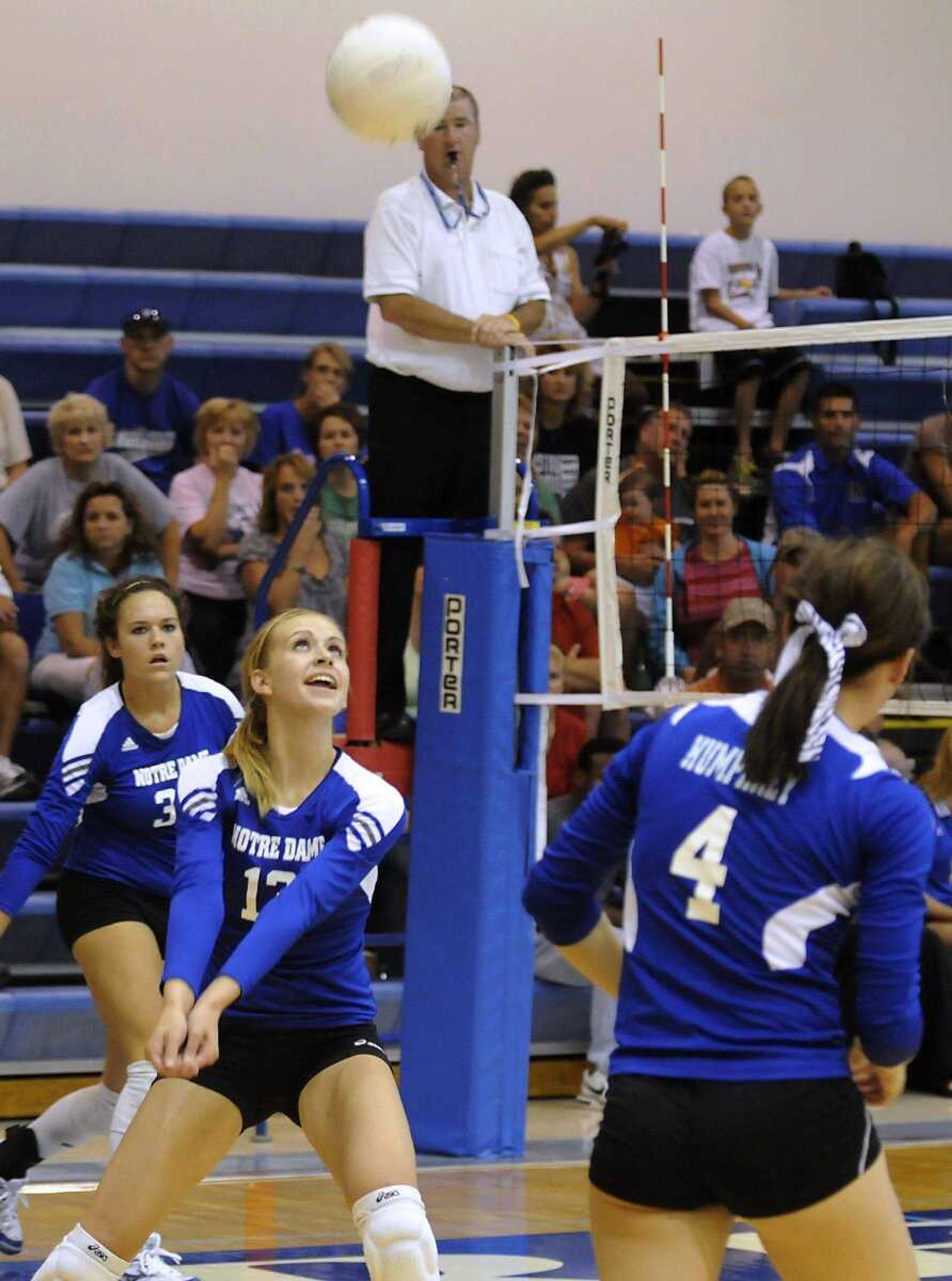 Notre Dame's Kate Edwards passes the ball as teammates Amy Wibbenmeyer, left, and Ashley Humphrey, right, look on during the first game of the final match of Notre Dame VolleyballFest on Saturday, September 4, 2010, at Notre Dame High School in Cape Girardeau. Perryville defeated Notre Dame 2-0. (Kristin Eberts)