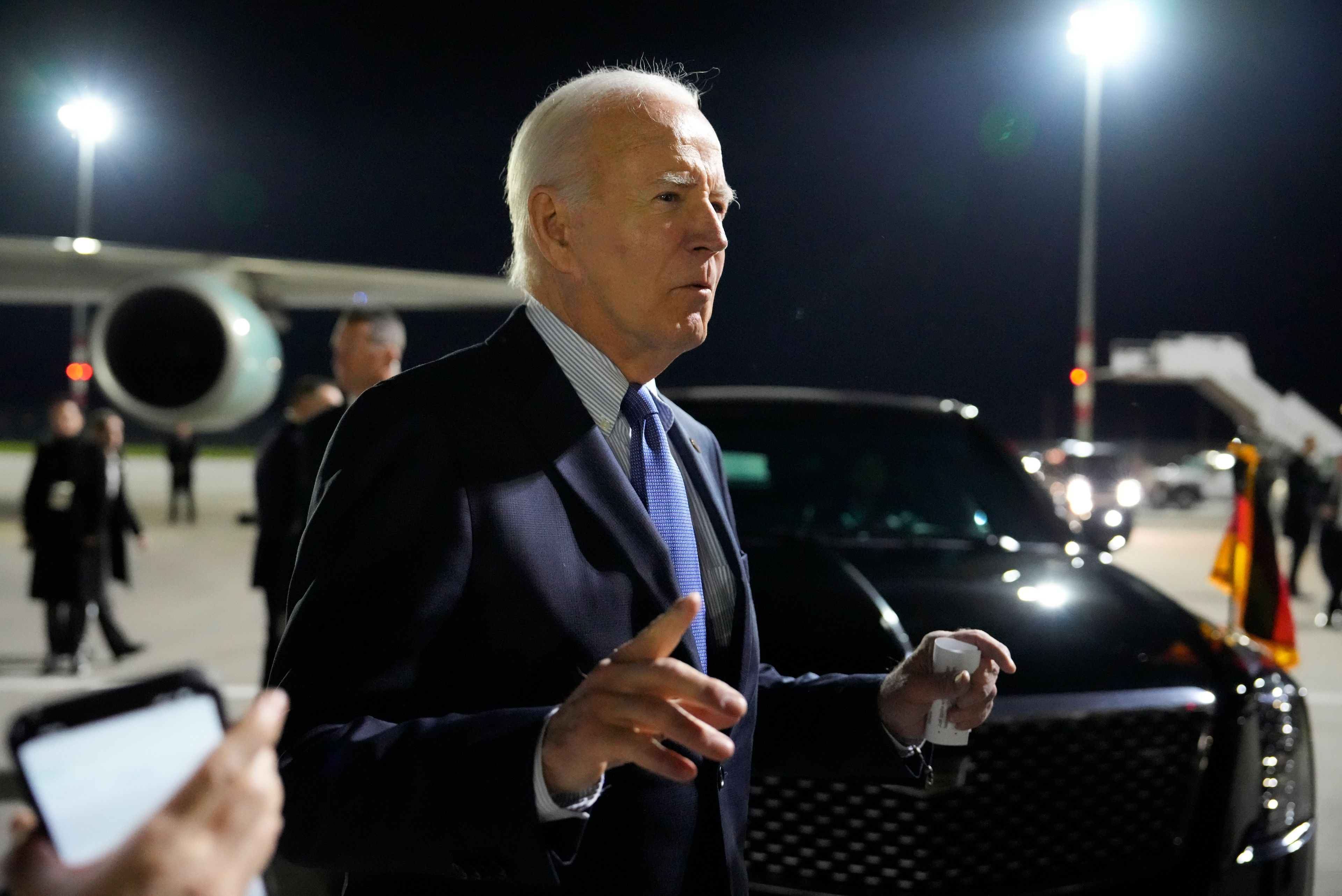 President Joe Biden gestures as he speaks after arriving at Brandenburg Airport in Schoenefeld near Berlin, Germany, Thursday, Oct. 17, 2024. (AP Photo/Ben Curtis)