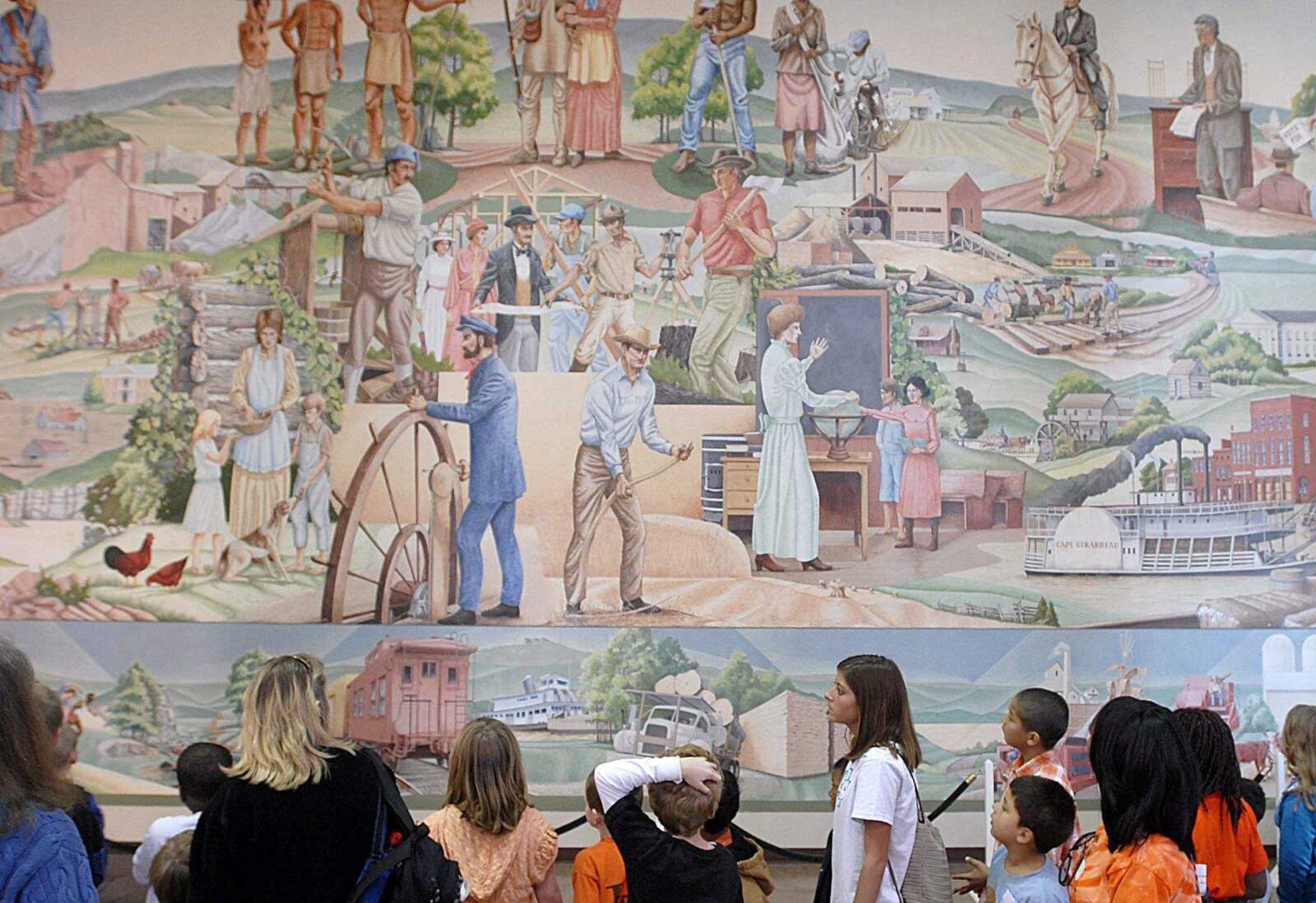 AARON EISENHAUER ~ aeisenhauer@semissourian.com
Students pause to inspect a large mural in the lobby of Kent Library.