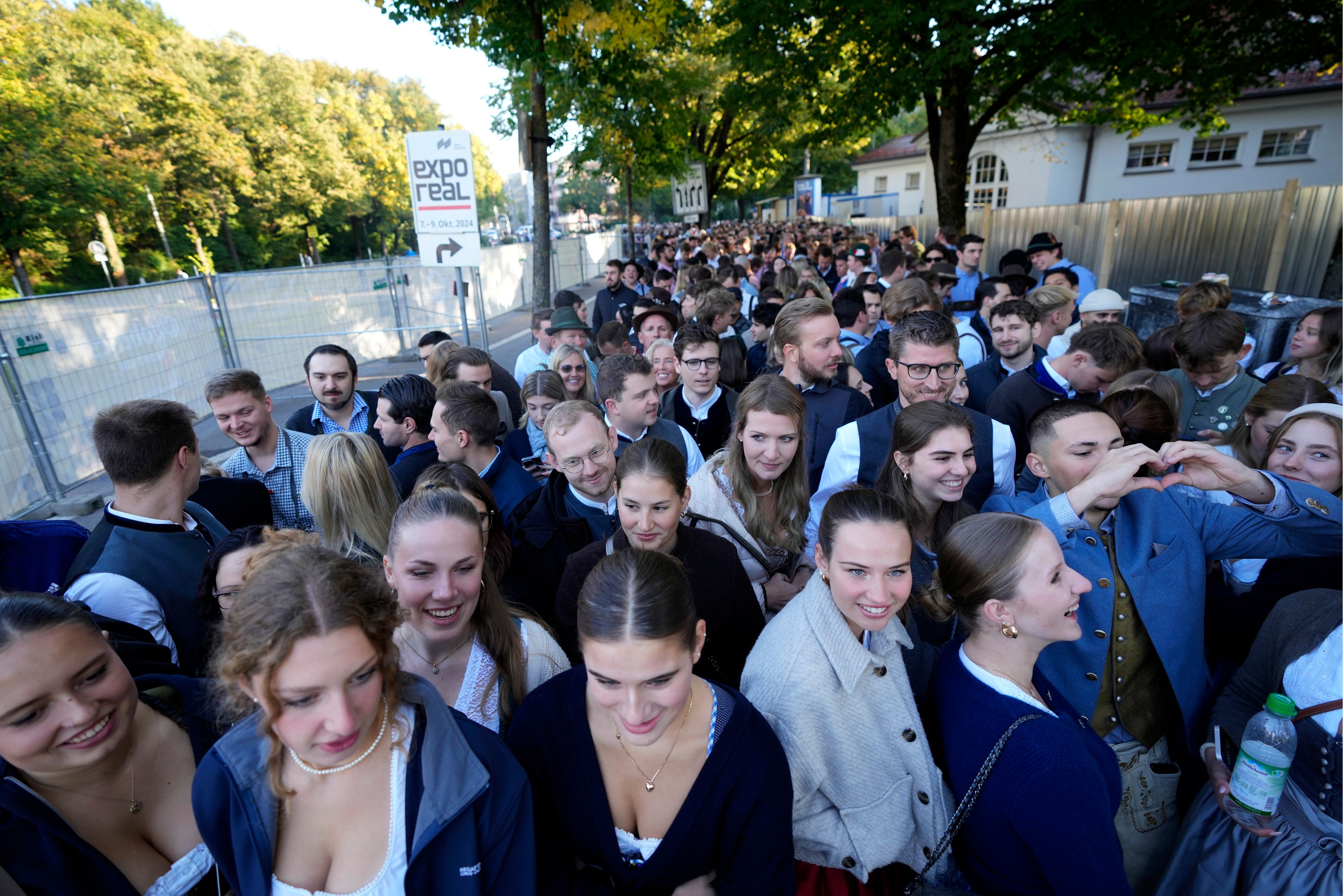 Young visitors await the start of the 189th 'Oktoberfest' beer festival in Munich, Germany, Saturday, Sept. 21, 2024. (AP Photo/Matthias Schrader)