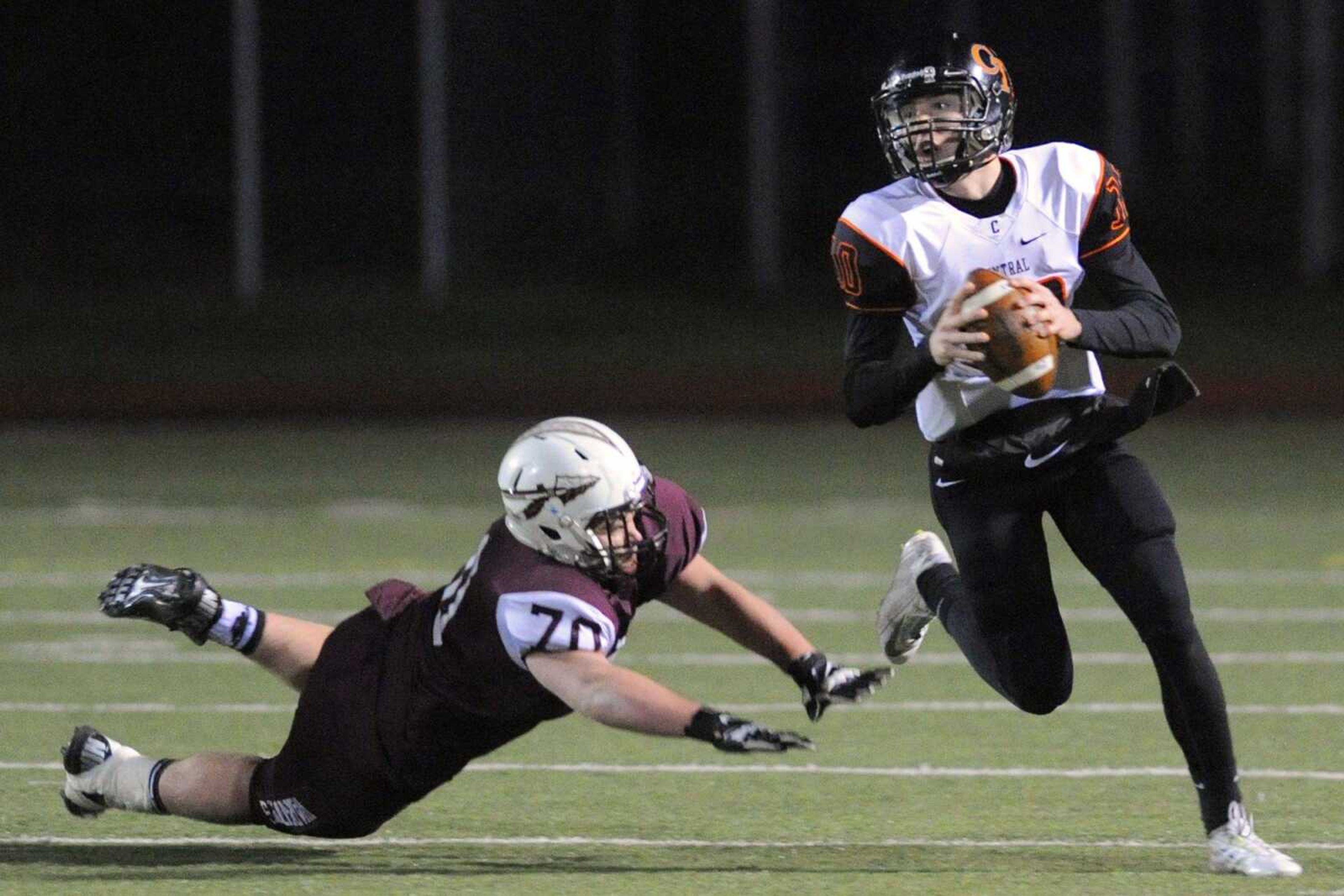 Central quarterback Peyton Montgomery works past St. Charles West defensive tackle Brandon Carey during the second quarter in the  Class 4 semifinal Friday, Nov. 21, 2014 in St. Charles, Missouri. (Glenn Landberg)