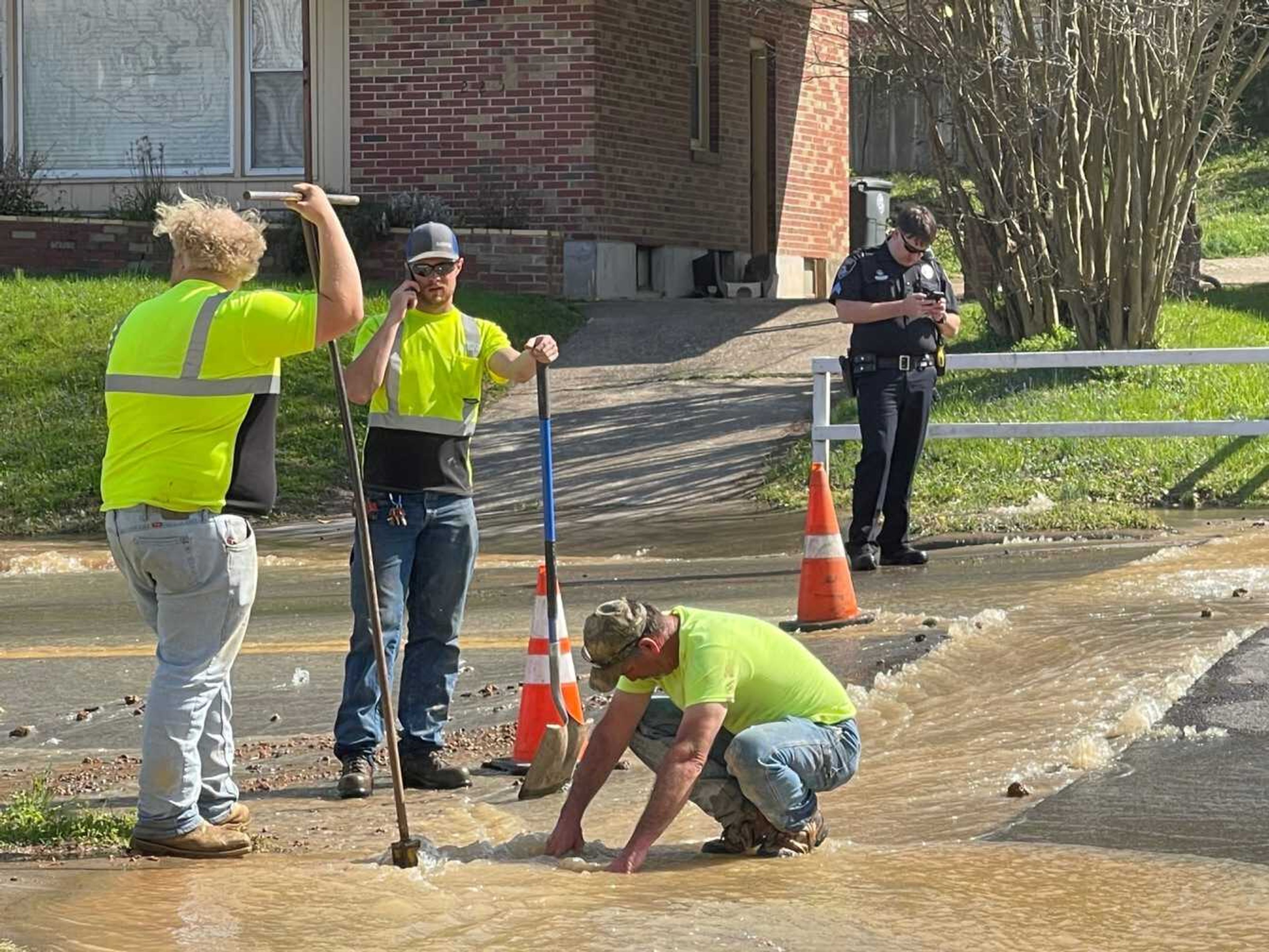 City of Cape Girardeau workers try to shut off water at the intersection of William and Lorimier streets. A cut water main disrupted supply in the area about 3:30 p.m. Friday.