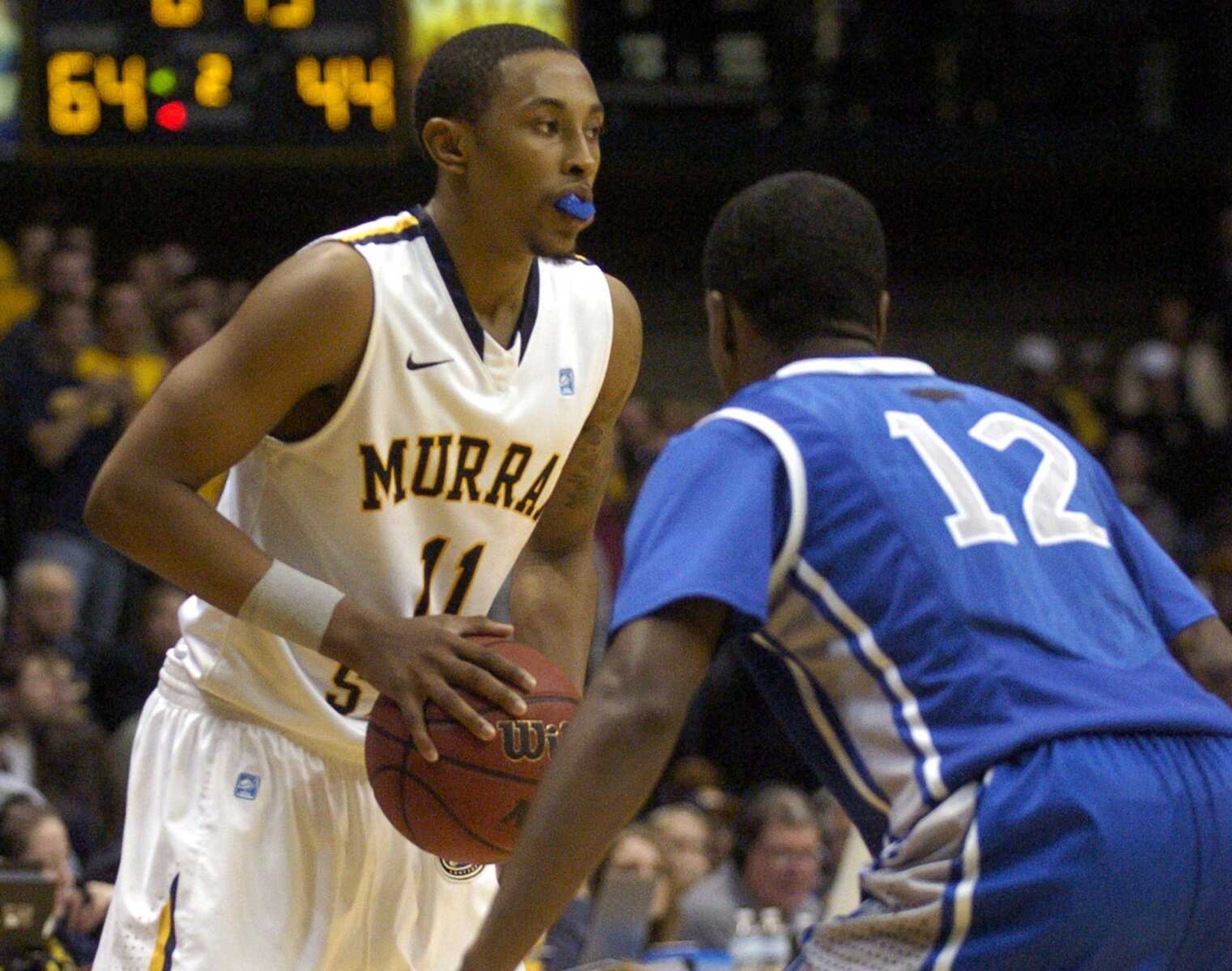 Murray State's Donte Poole, left, looks to make a move from the sideline while pressured by Eastern Illinois' Jeremy Granger in the second half of an NCAA college basketball game on Saturday, Jan. 28, 2012, in Murray, Ky. (AP Photo/Lance Dennee)