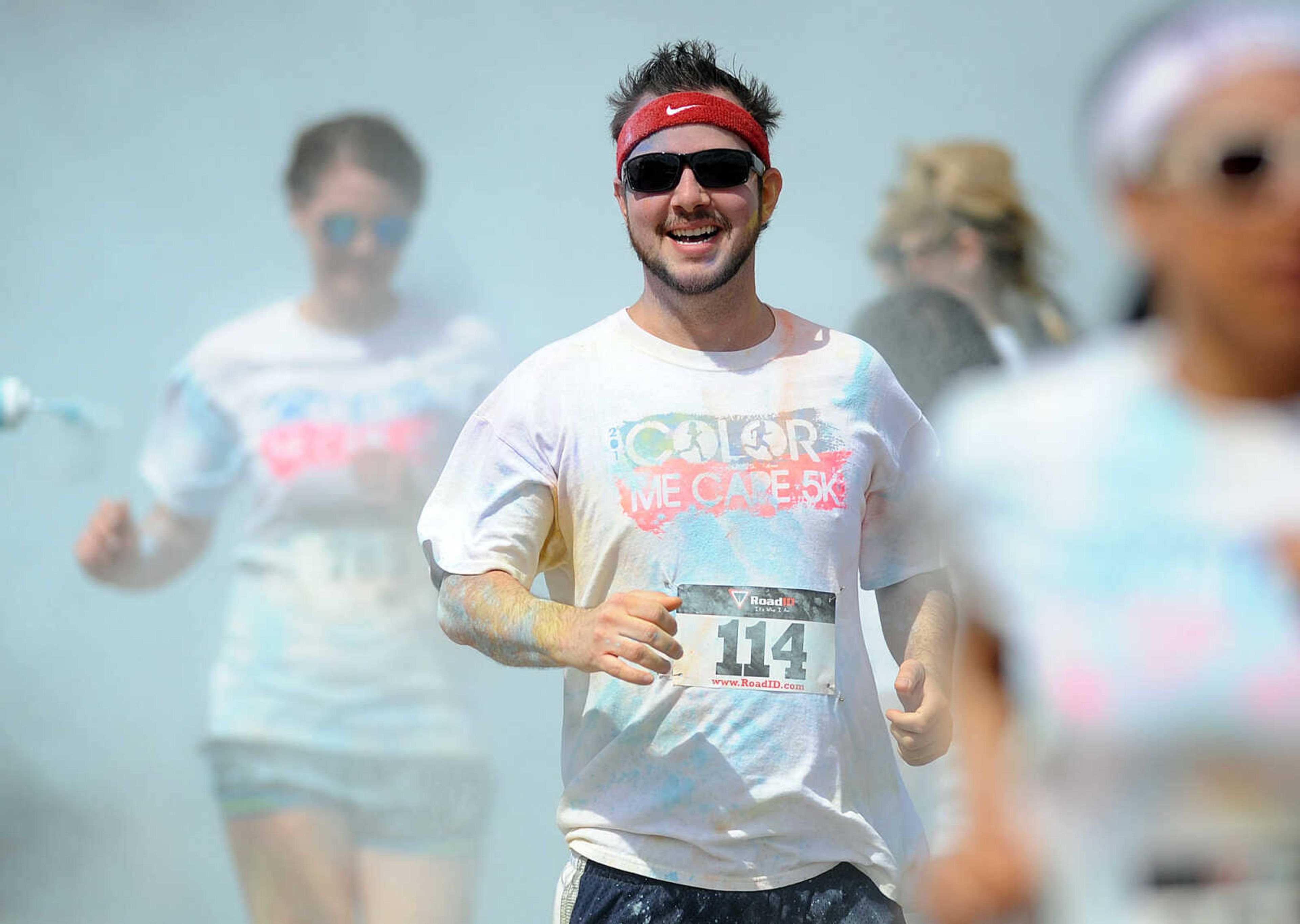 LAURA SIMON ~ lsimon@semissourian.com

Participants in the Color Me Cape 5K are sprayed with blue powder at the final color station on Main Street, Saturday, April 12, 2014, in Cape Girardeau.