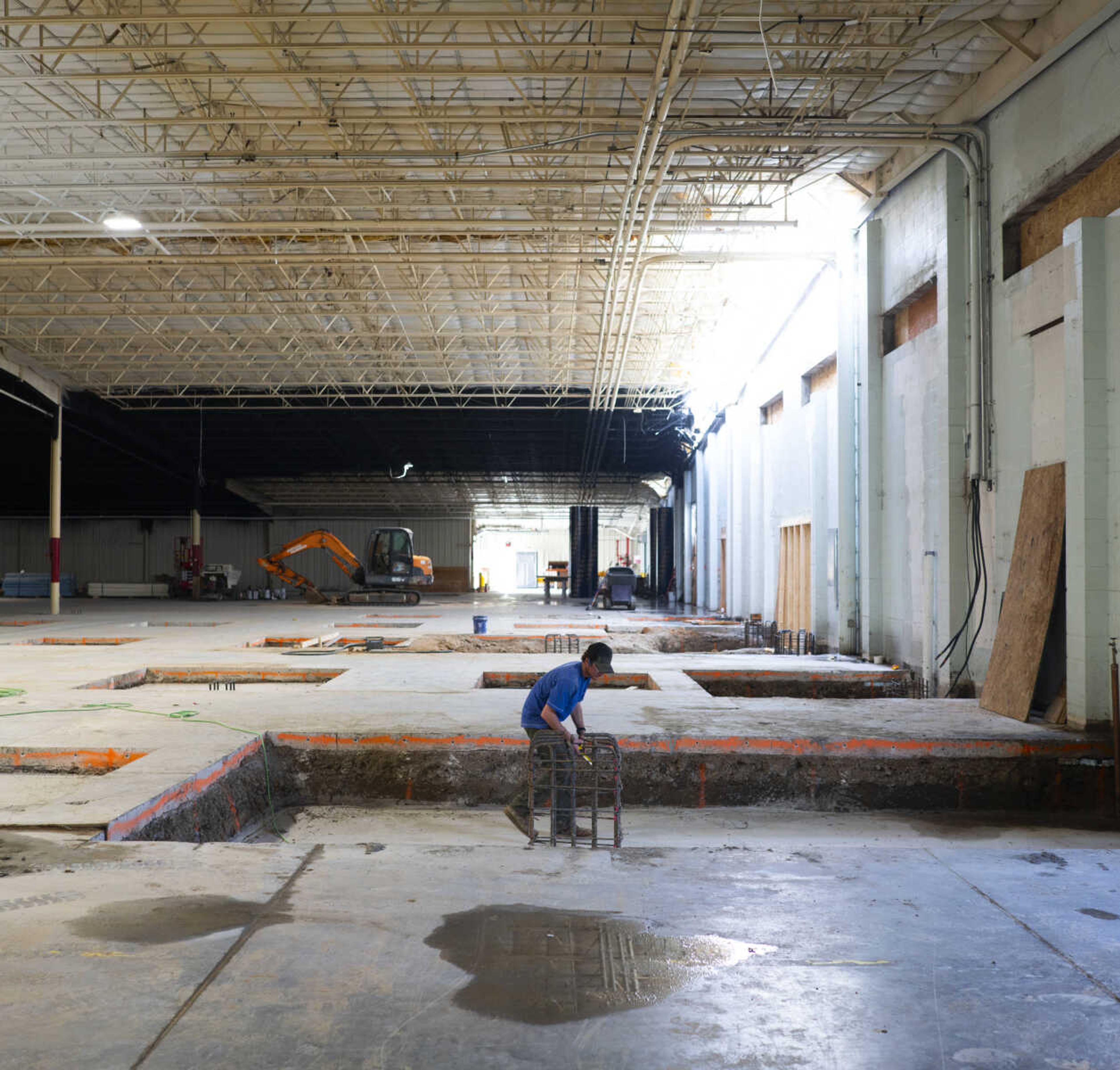 Workers construct a wall that will separate The Pickleball Factory from Parc Motor Club as the former Thorngate Factory is transformed. (Photo by Aaron Eisenhauer)