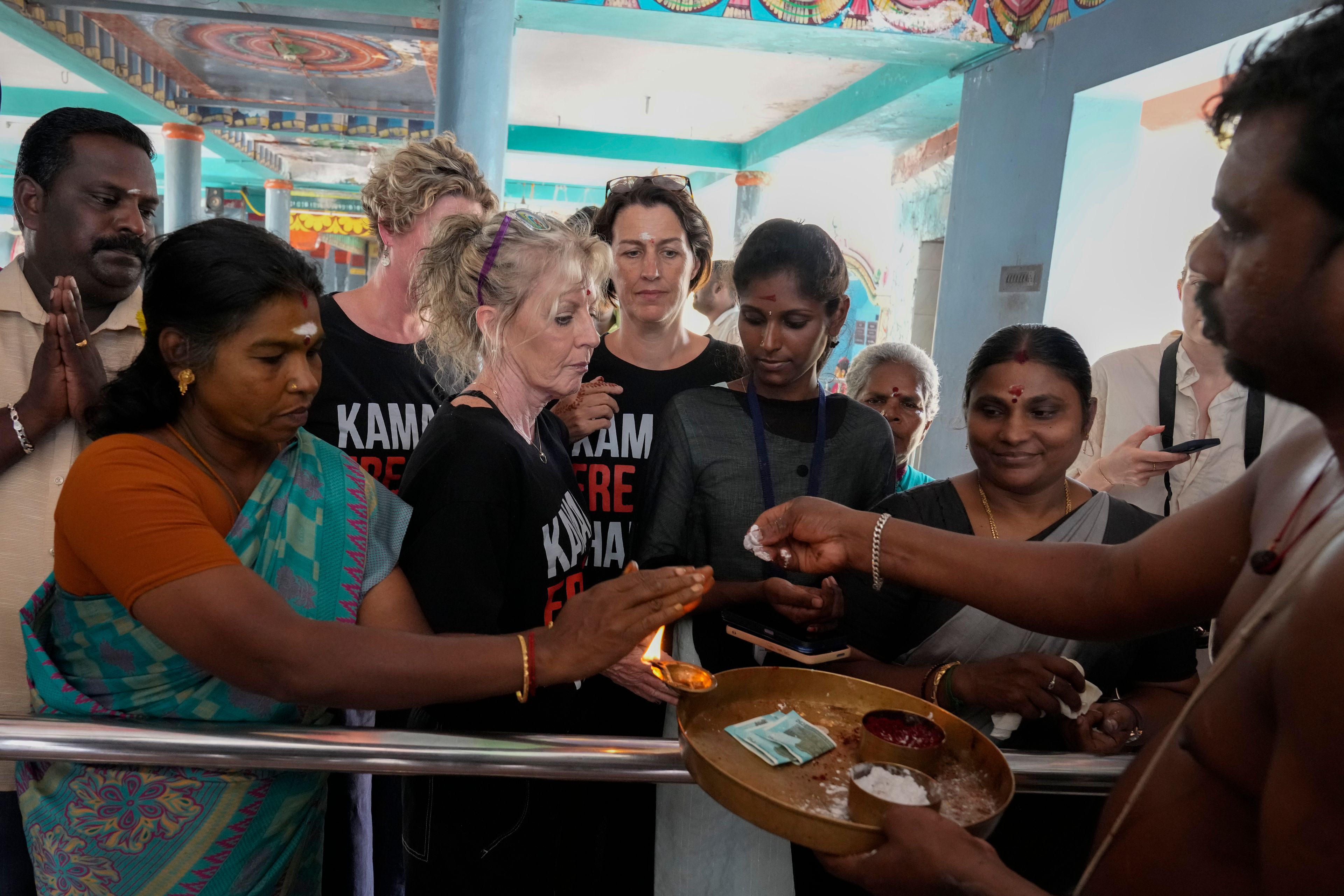 Local villagers and international tourists receive blessings from a priest after participating in special prayers for the victory of Democratic presidential nominee Vice President Kamala Harris, at Sri Dharmasastha Hindu temple in Thulasendrapuram, the ancestral village of Harris, in Tamil Nadu state, India, Tuesday, Nov. 5, 2024. (AP Photo/Aijaz Rahi)