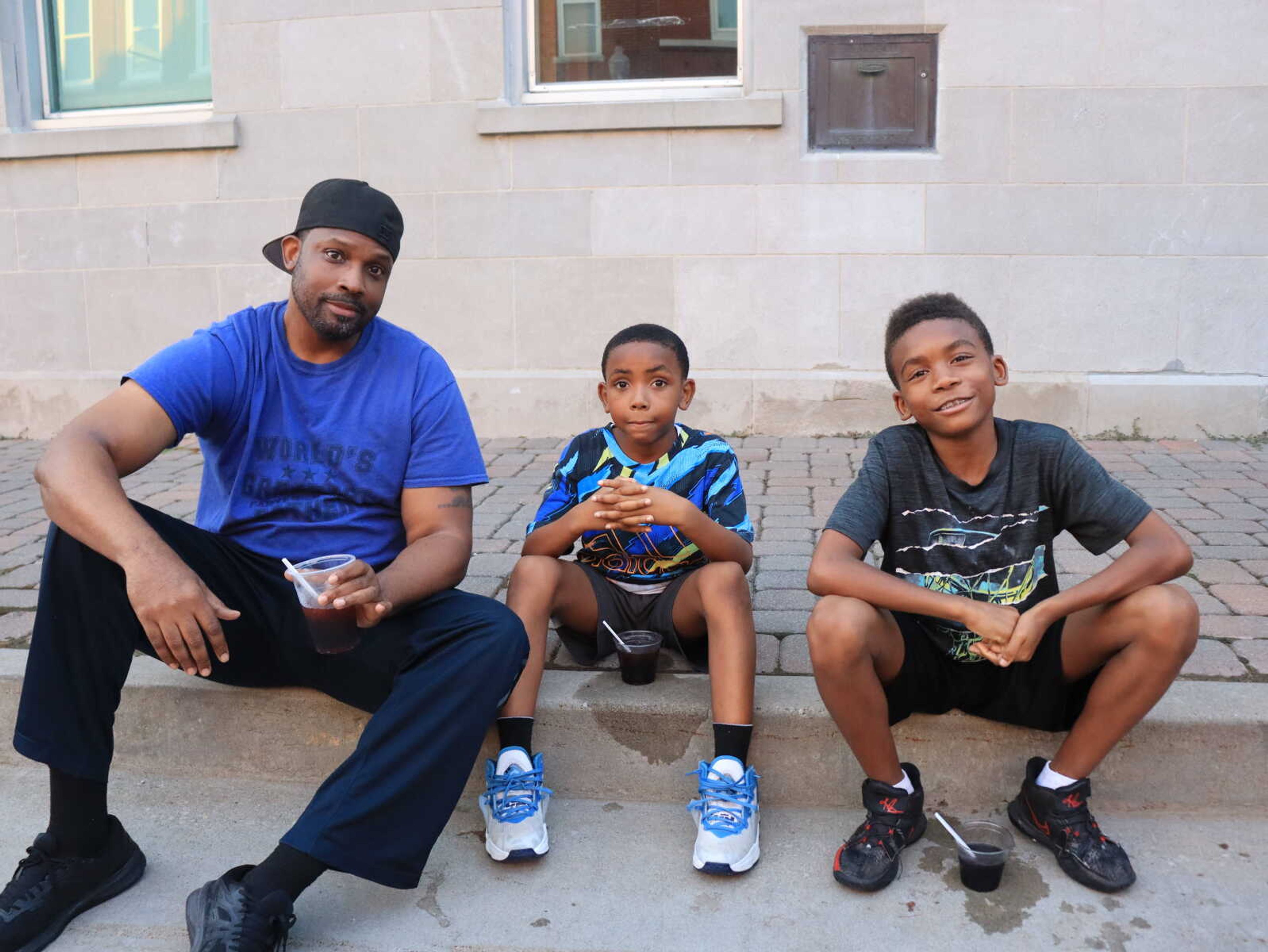 (Left) Rolando, Jibreel and Nasir Rodgers sit and take a break from the festivities at Jackson Homecomers on Thursday.