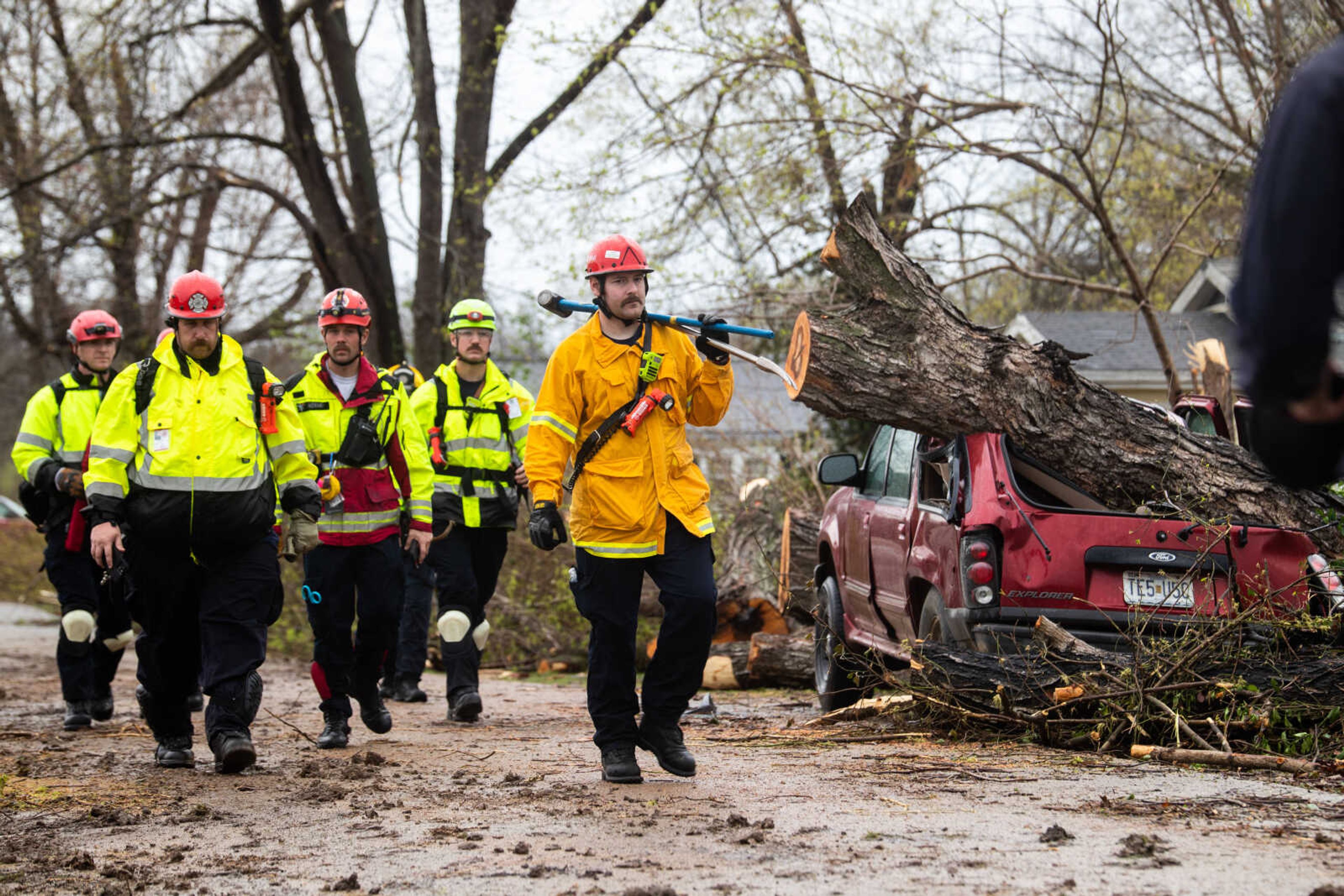 Emergency responders walk the roads of Glen Allen assessing the damage left by the tornado on Wednesday, April 5 in Glen Allen.