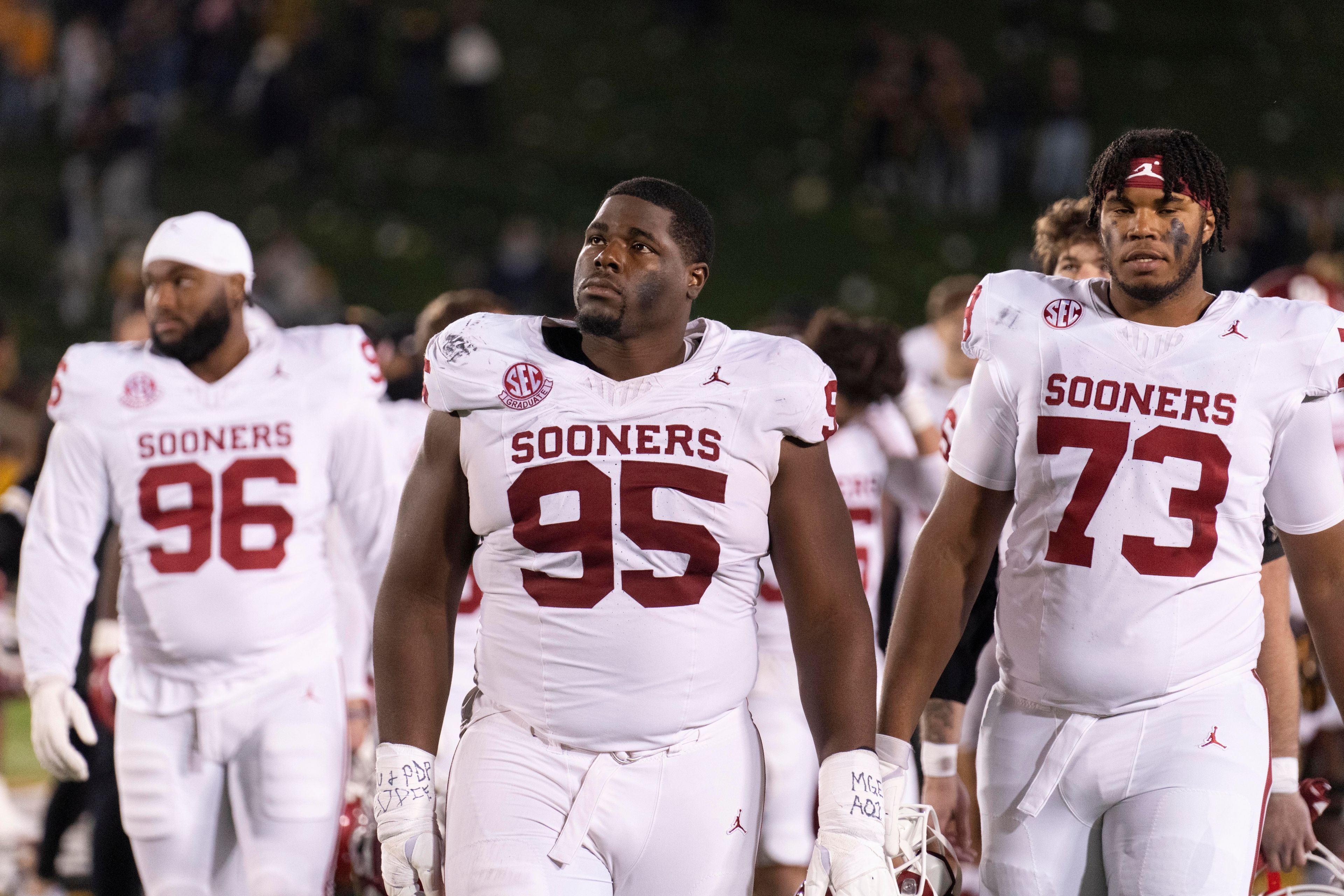 Oklahoma's Da'Jon Terry (95), Isaiah Autry-Dent, (73) and Davon Sears (96) walk off the field after losing 30-23 to Missouri in an NCAA college football game Saturday, Nov. 9, 2024, in Columbia, Mo. (AP Photo/L.G. Patterson)