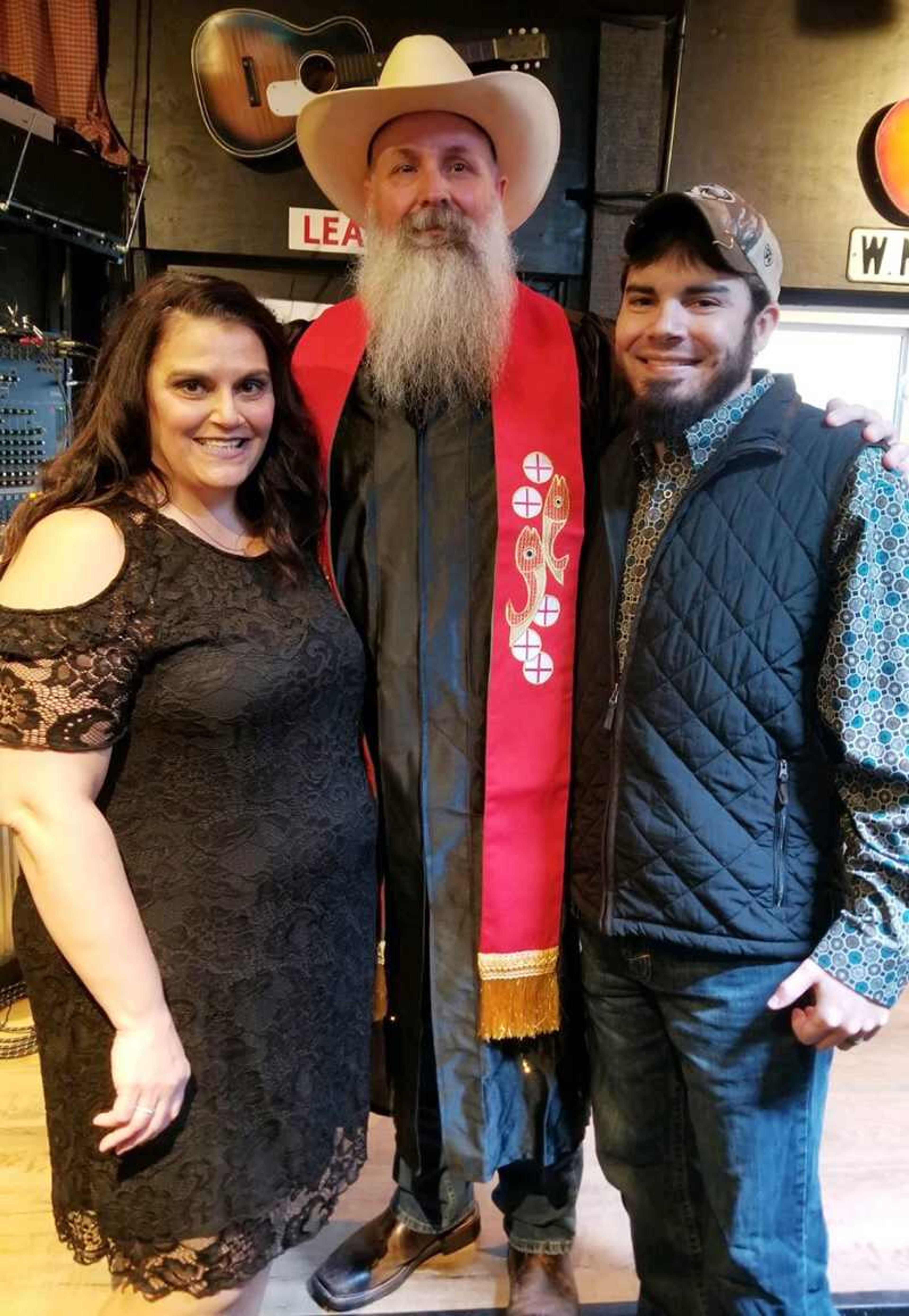 Mr. and Mrs. Travis Sievers with Rodney Barnes, center, who performed the ceremony.