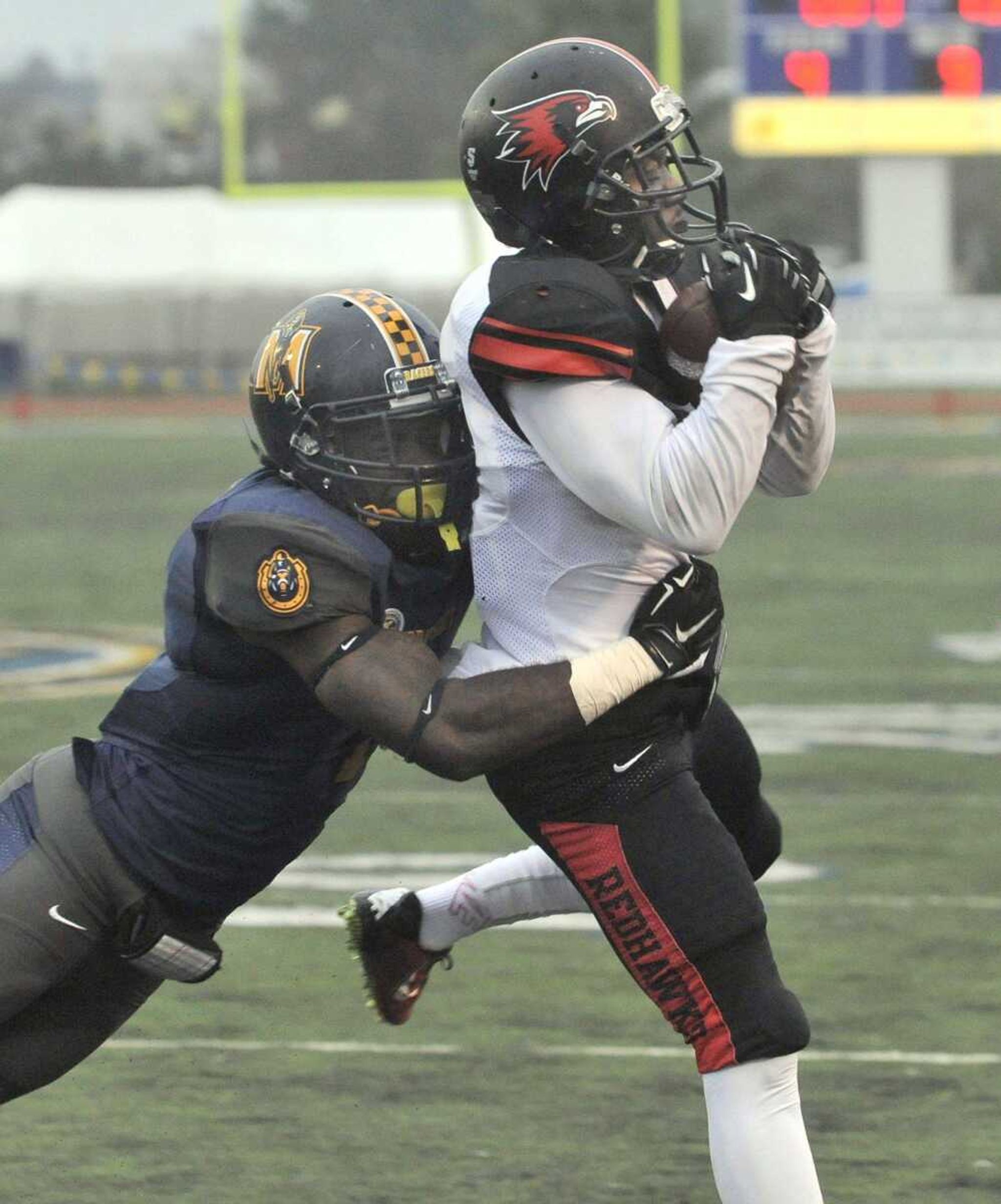 Southeast Missouri State's Peter Lloyd catches a 9-yard pass from quarterback Kyle Snyder before he is tackled by Murray State's Shawn Samuels-Connell during the fourth quarter Saturday, Oct. 11, 2014 in Murray, Kentucky. (Fred Lynch)