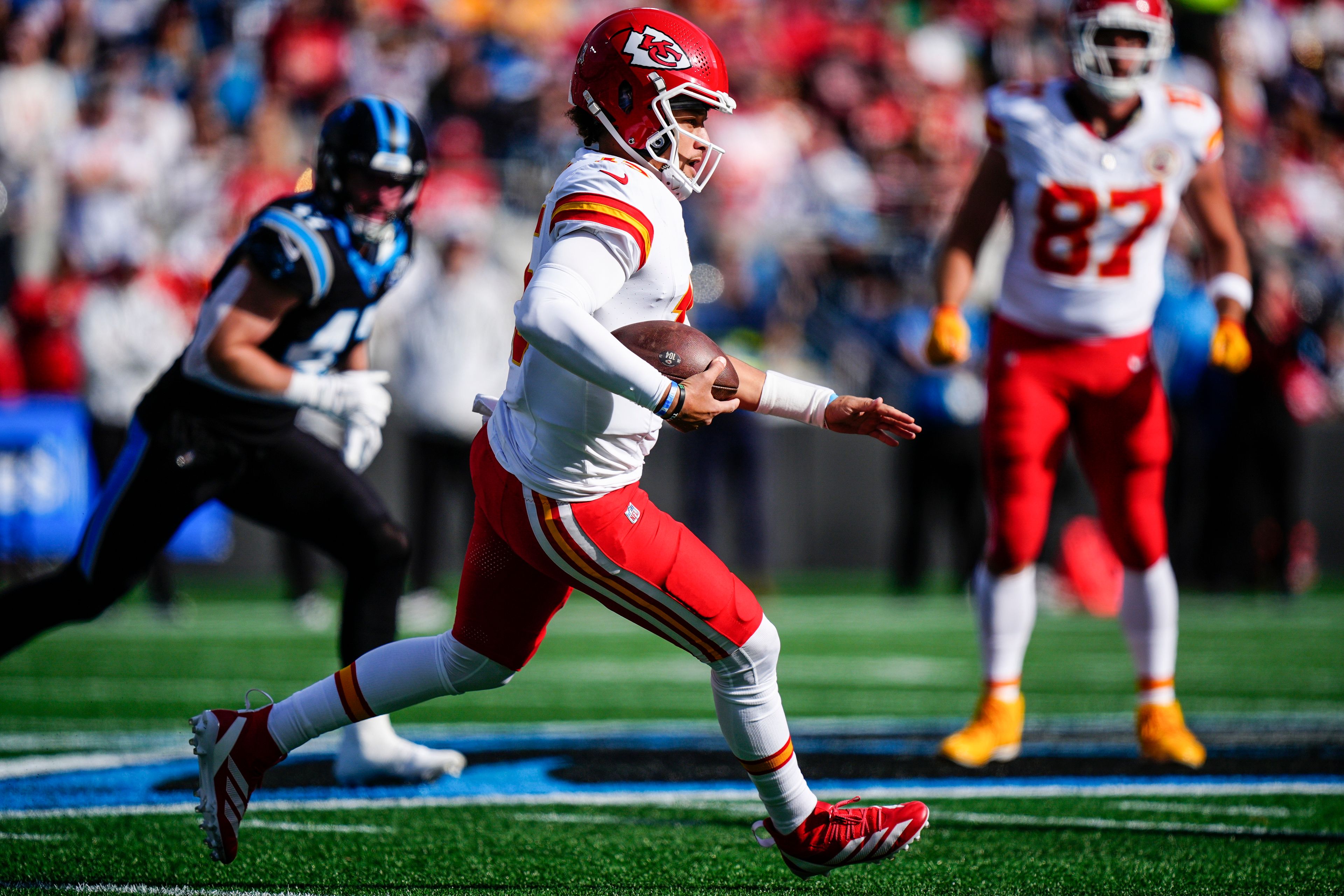 Kansas City Chiefs quarterback Patrick Mahomes (15) runs down field against the Carolina Panthers during the first half of an NFL football game, Sunday, Nov. 24, 2024, in Charlotte, N.C. (AP Photo/Jacob Kupferman)