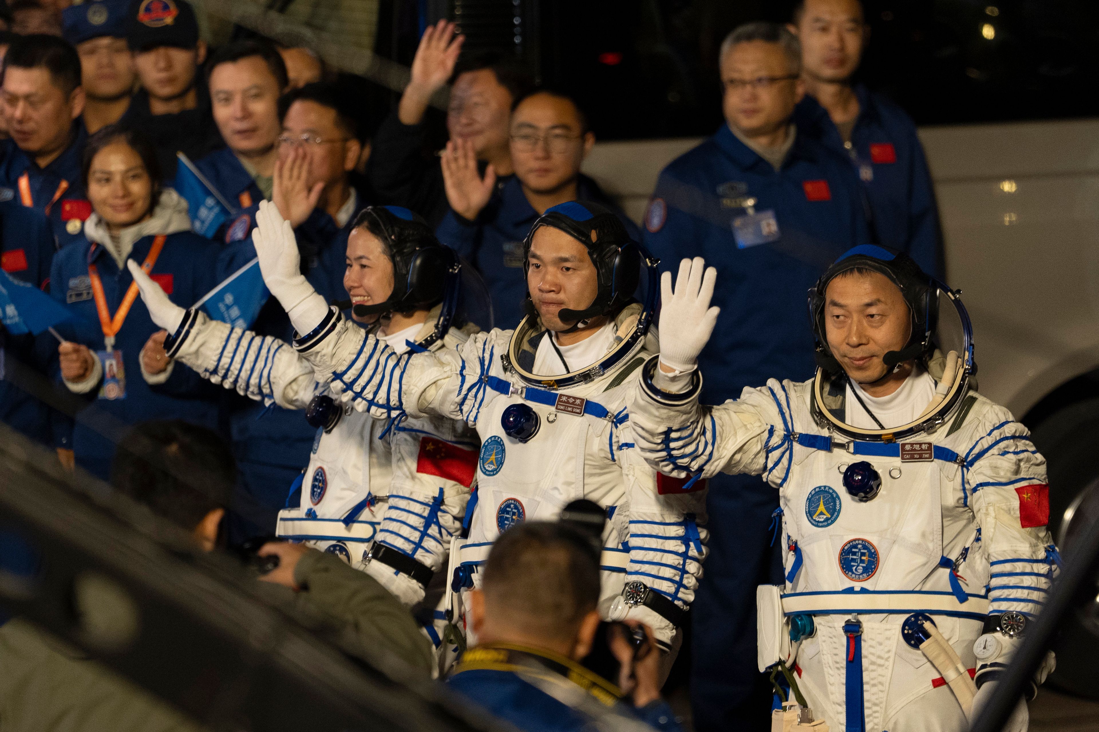 Chinese astronauts Wang Haoze, from left, Song Lingdong and Cai Xuzhe wave during the see-off ceremony for the Shenzhou-19 mission at the Jiuquan Satellite Launch Center in northwestern China, in the early hours of Wednesday, Oct. 30, 2024. (AP Photo/Ng Han Guan)