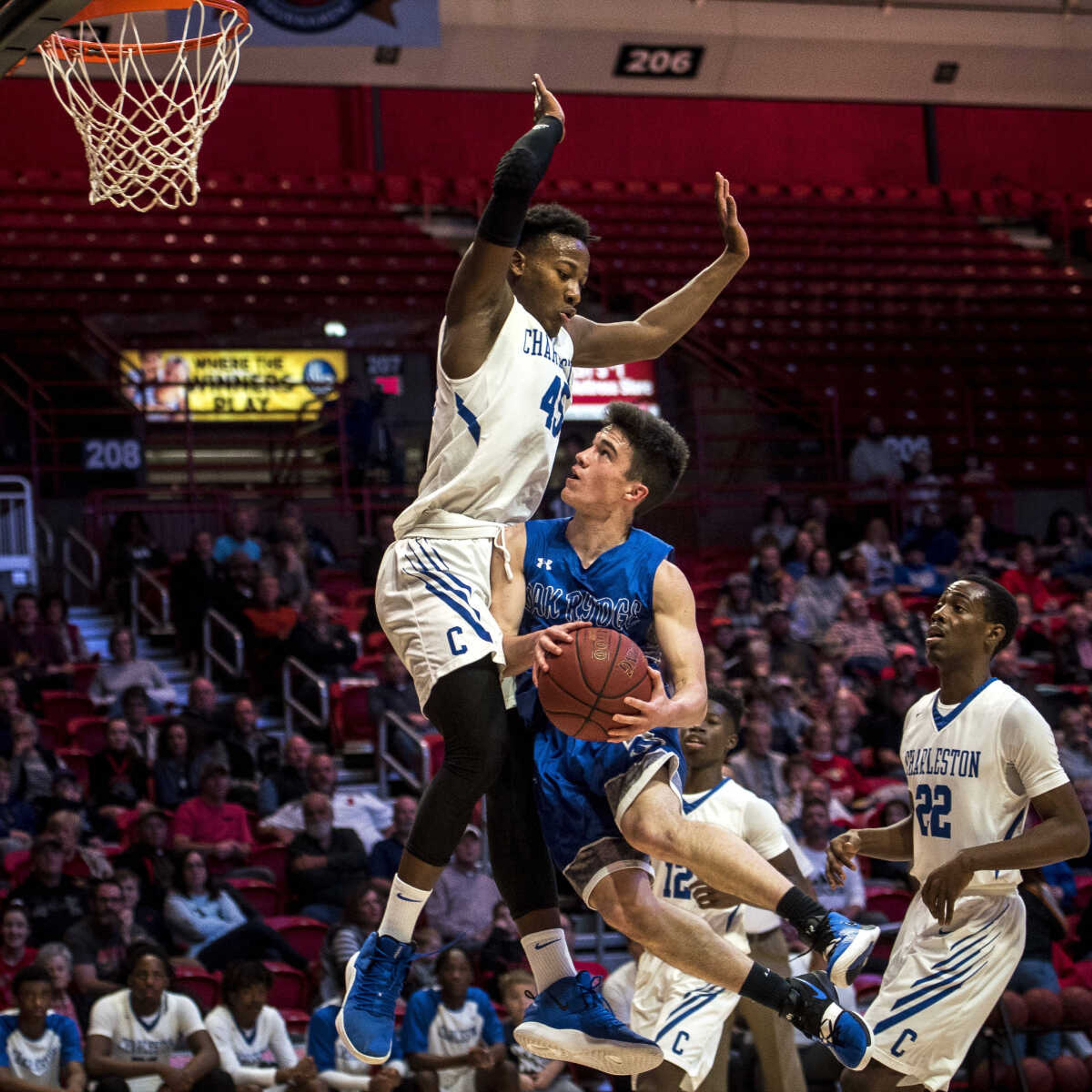 Charleston junior Blessin Kimble (45) looms over Oak Ridge junior David Layton (24) as Layton tries to shoot during the Blue Jays' day two matchup against Oak Ridge during the Southeast Missourian Christmas Tournament at the Show Me Center Thursday, Dec. 27, 2018. Kimble fouled Layton on this play, but Charleston won the game 67-52.