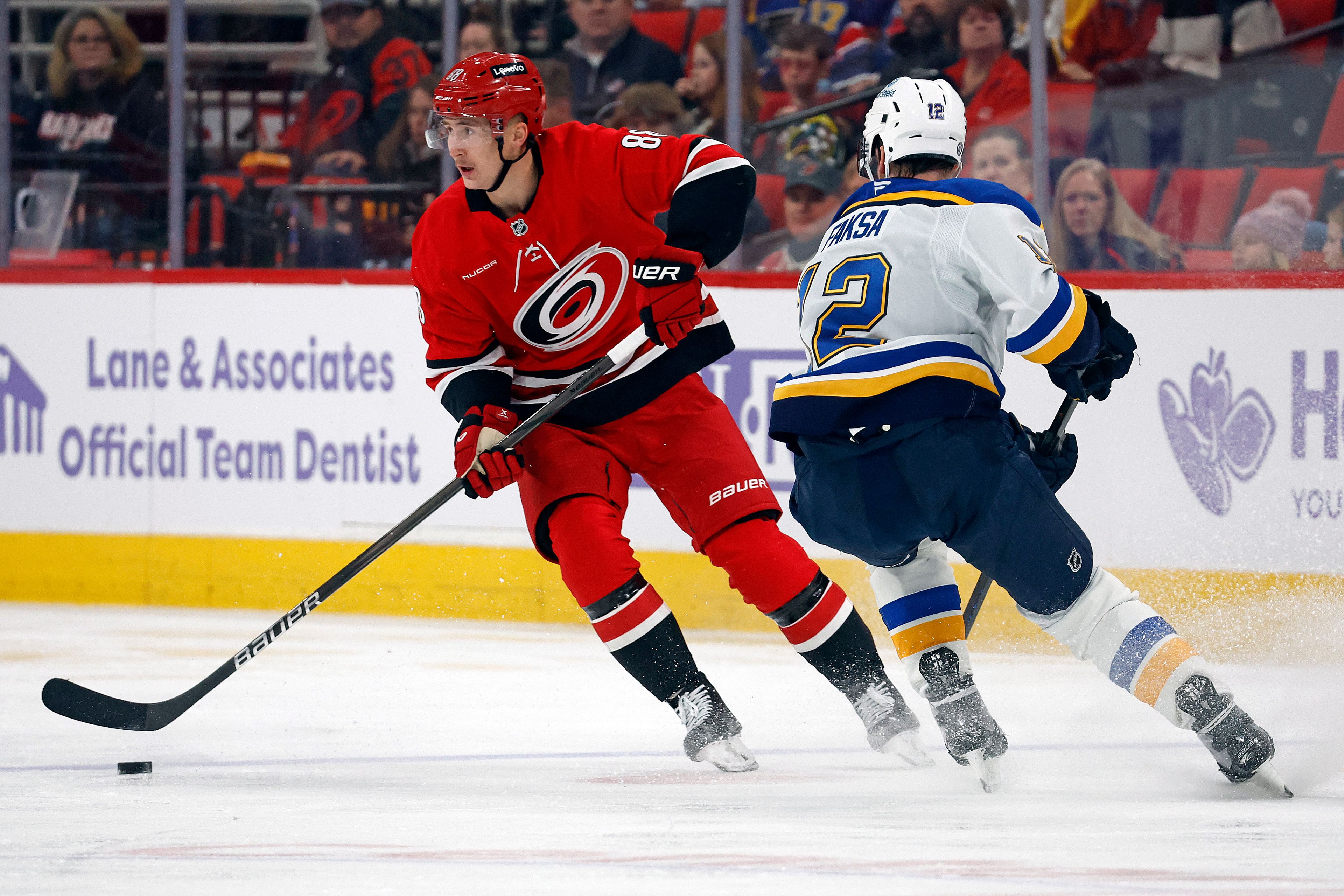 Carolina Hurricanes' Martin Necas (88) controls the puck near St. Louis Blues' Radek Faksa (12) during the second period of an NHL hockey game in Raleigh, N.C., Sunday, Nov. 17, 2024. (AP Photo/Karl B DeBlaker)