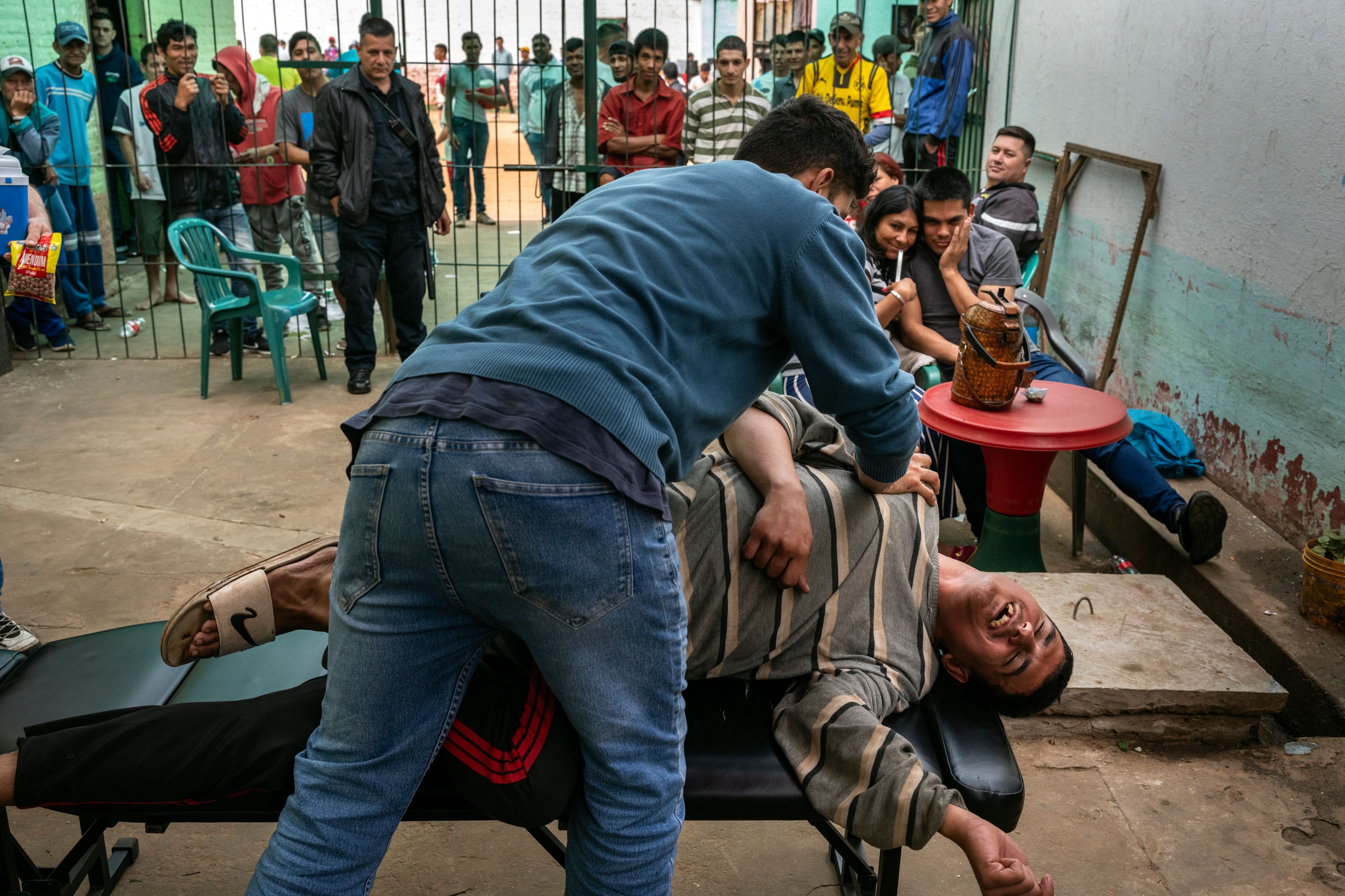 A prisoner gives a free stretching session to a volunteer during events on visiting day at the Regional Penitentiary in Villarica, Paraguay, Sunday, Sept. 1, 2024. (AP Photo/Rodrigo Abd)