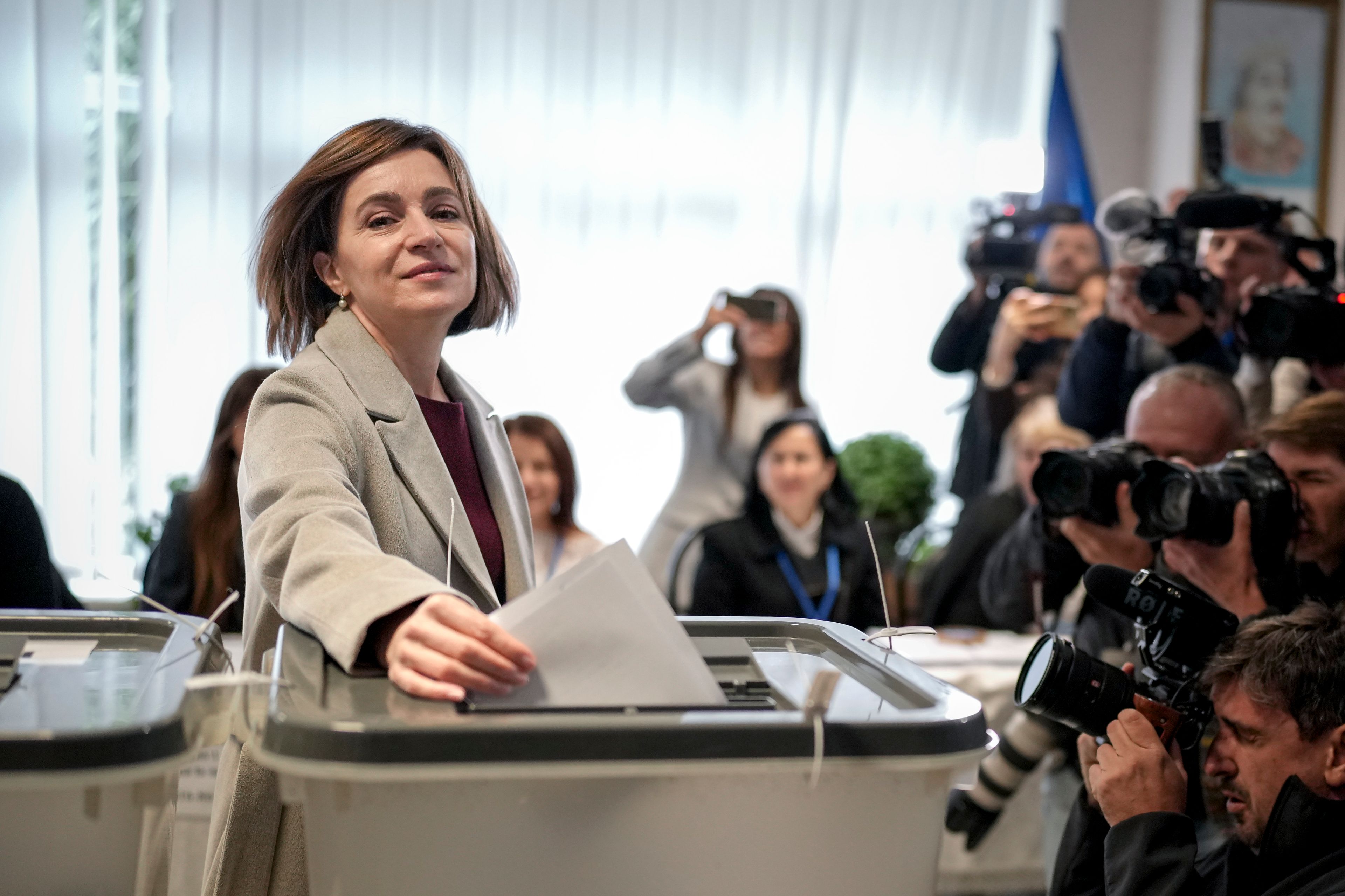 Moldova's President Maia Sandu prepares to cast her vote, in Chisinau, Moldova, Sunday, Oct. 20, 2024, during a presidential election and a referendum on whether to enshrine in the Constitution the country's path to European Union membership. (AP Photo/Vadim Ghirda)