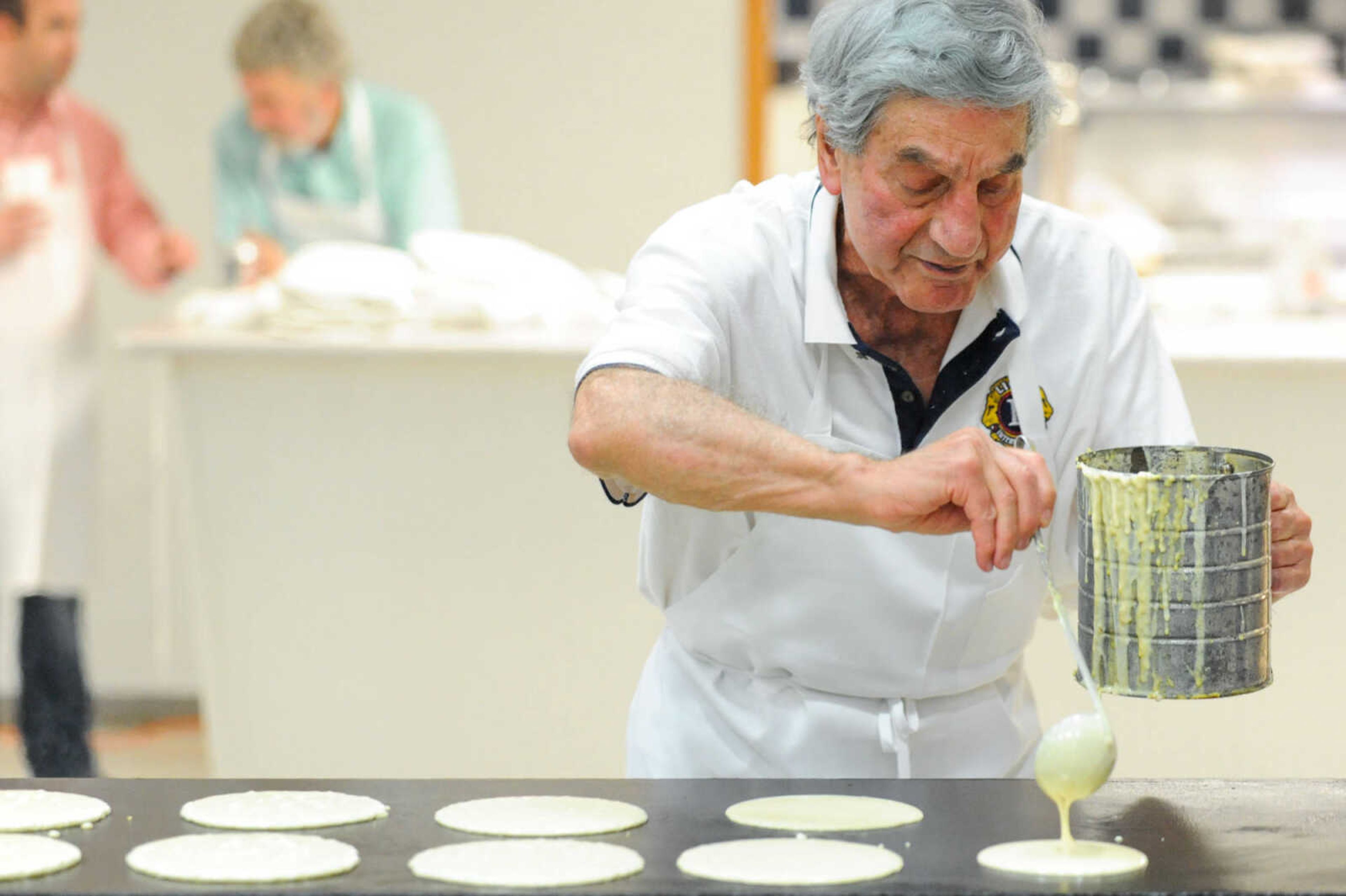 GLENN LANDBERG ~ glandberg@semissourian.com

Edwin Noffel lays down a fresh batch of pancakes during the 78th annual Noon Lions Club Pancake Day Wednesday, March 9, 2016 at the Arena Building in Cape Girardeau. Noffel has been manning the grill for 53 years.