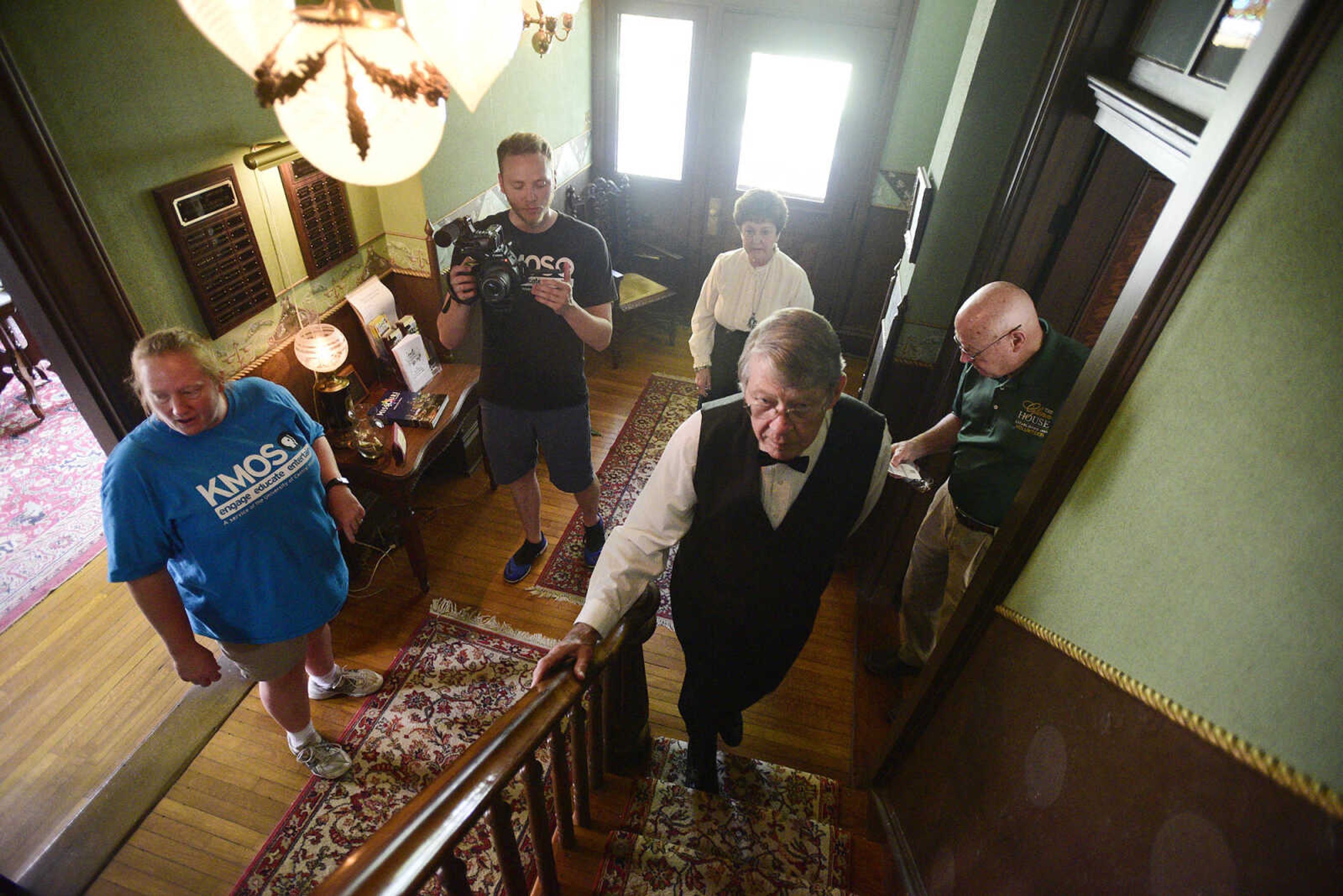 Eric Boedeker from KMOS-TV film Tom Bass as he climbs the staircase inside the Glenn House on Wednesday, Aug. 16, 2017, in Cape Girardeau. KMOS-TV, a PBS affiliate, was filming inside the historic home for its Missouri Life show.