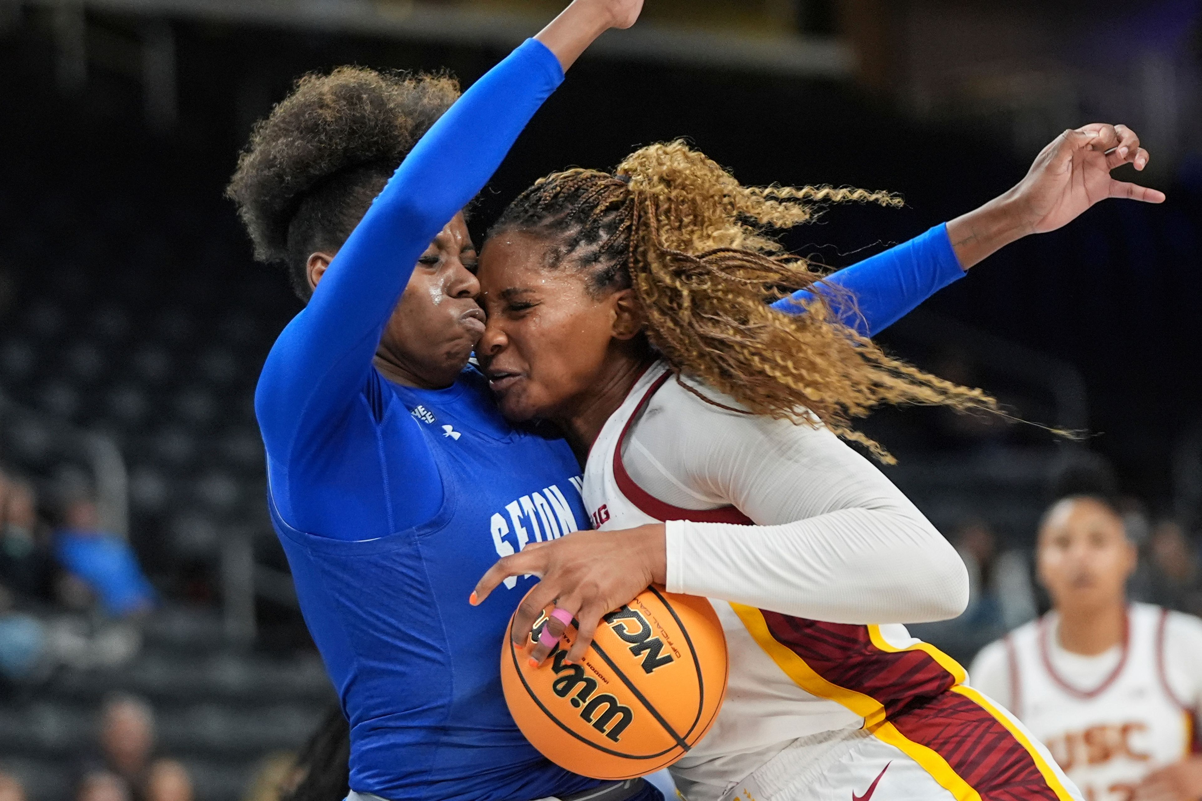 Southern California forward Kiki Iriafen, right, collides with Seton Hall forward Yaya Lops during the second half of an NCAA women's college basketball game in Palm Desert, Calif., Wednesday, Nov. 27, 2024. (AP Photo/Jae C. Hong)