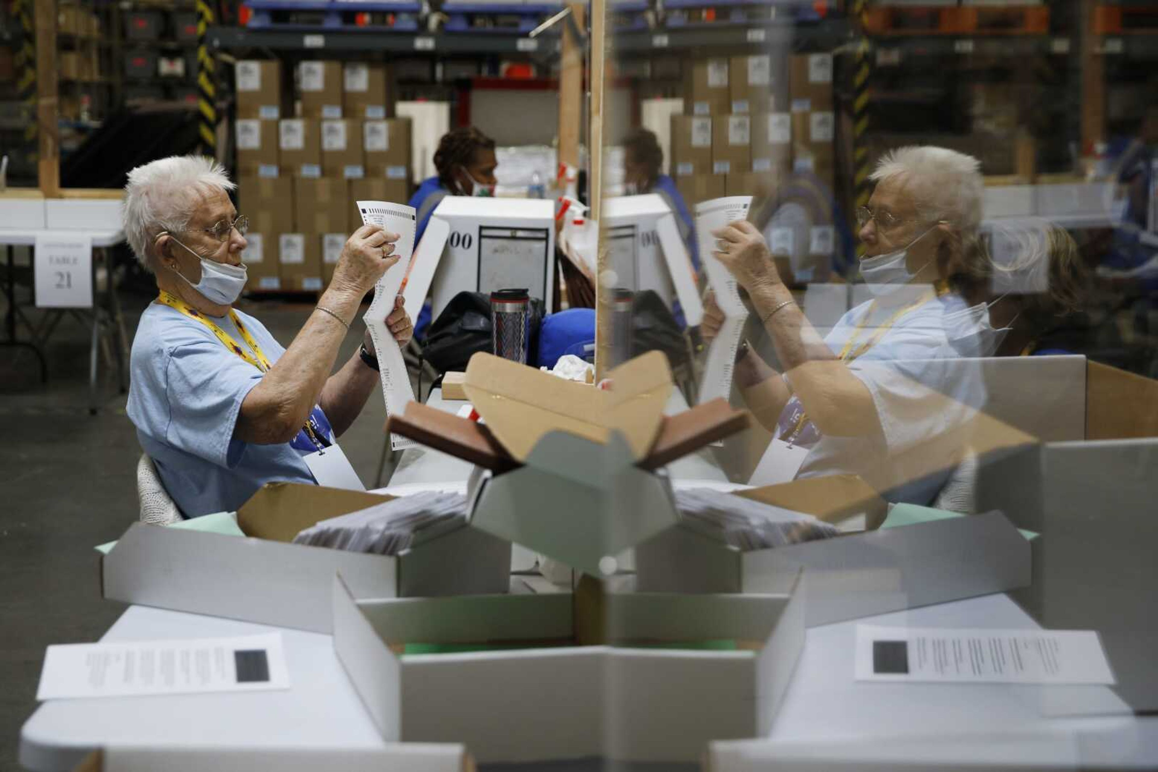 FILE - In this June 9, 2020, file photo, election workers process mail-in ballots during a nearly all-mail primary election in Las Vegas.  (AP Photo/John Locher, File)