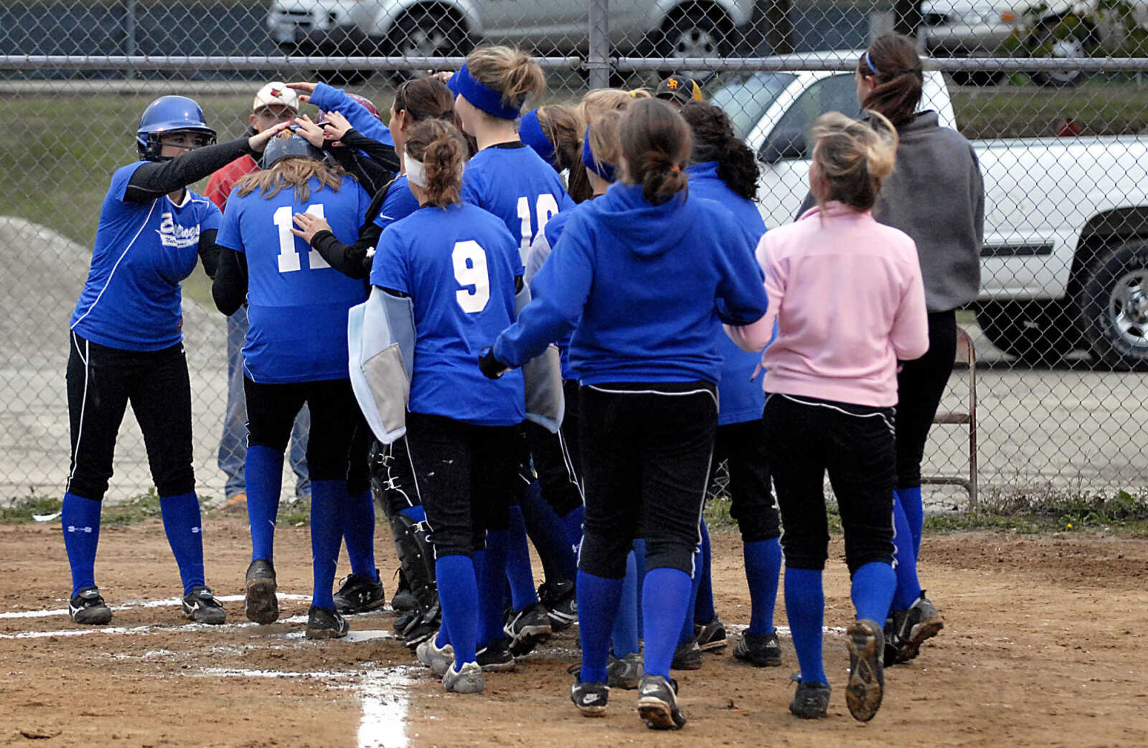 KIT DOYLE ~ kdoyle@semissourian.com
Notre Dame players congratulate senior Jane Morrill (11), left, after her two-run homer in the first inning against DeSoto Thursday, October 15, 2009, in Poplar Bluff.