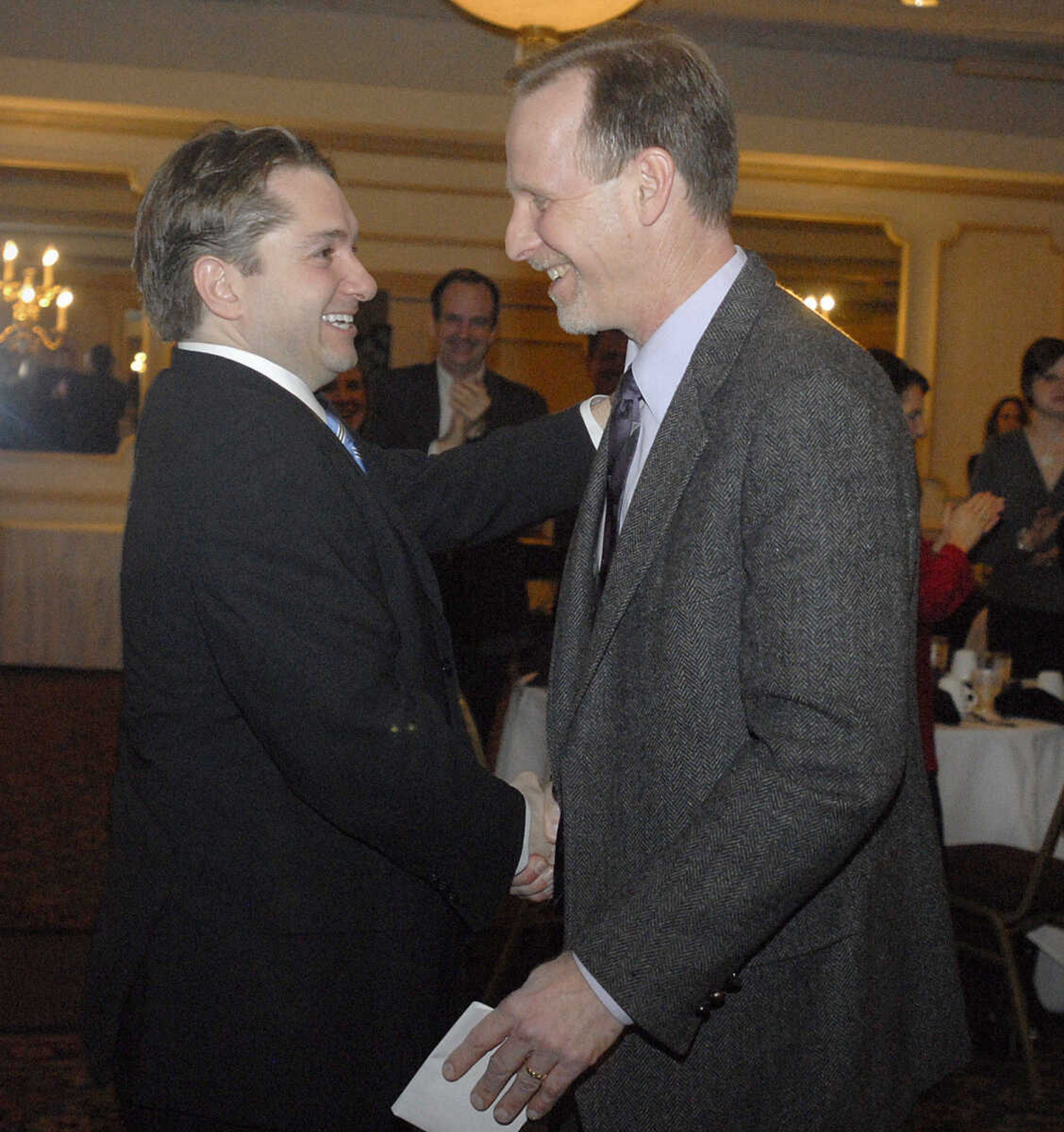 LAURA SIMON~lsimon@semissourian.com
From left: Jon Rust, publisher and co-president of Rust Communications, congratulates Mike Tenholder, general manager of Concord Printing Services, on receiving the American Advertising Federation's Silver Medal Award Friday, February 19, 2010.