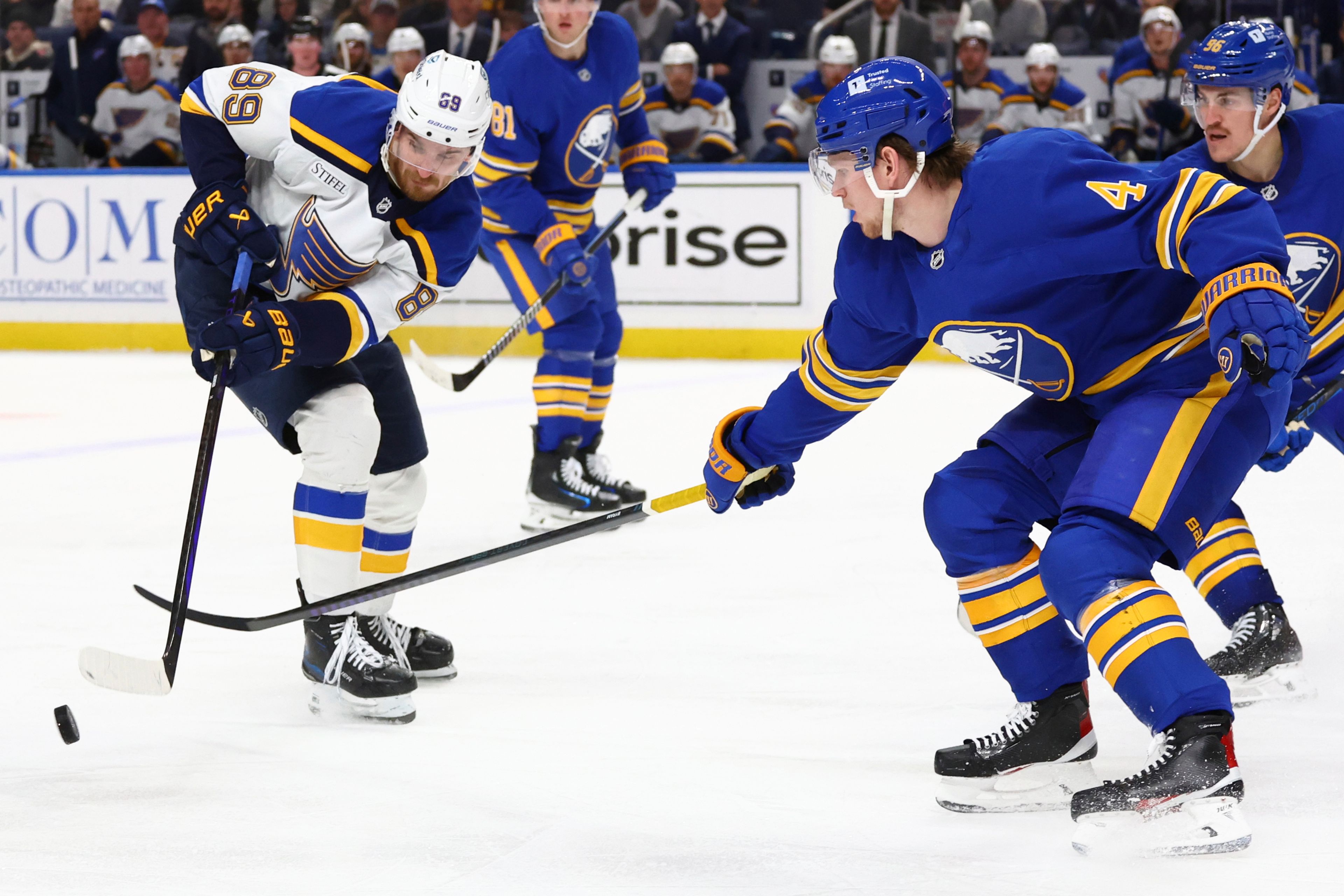 St. Louis Blues left wing Pavel Buchnevich (89) is stick-checked by Buffalo Sabres defenseman Bowen Byram (4) during the second period of an NHL hockey game Thursday, Nov. 14, 2024, in Buffalo, N.Y. (AP Photo/Jeffrey T. Barnes)