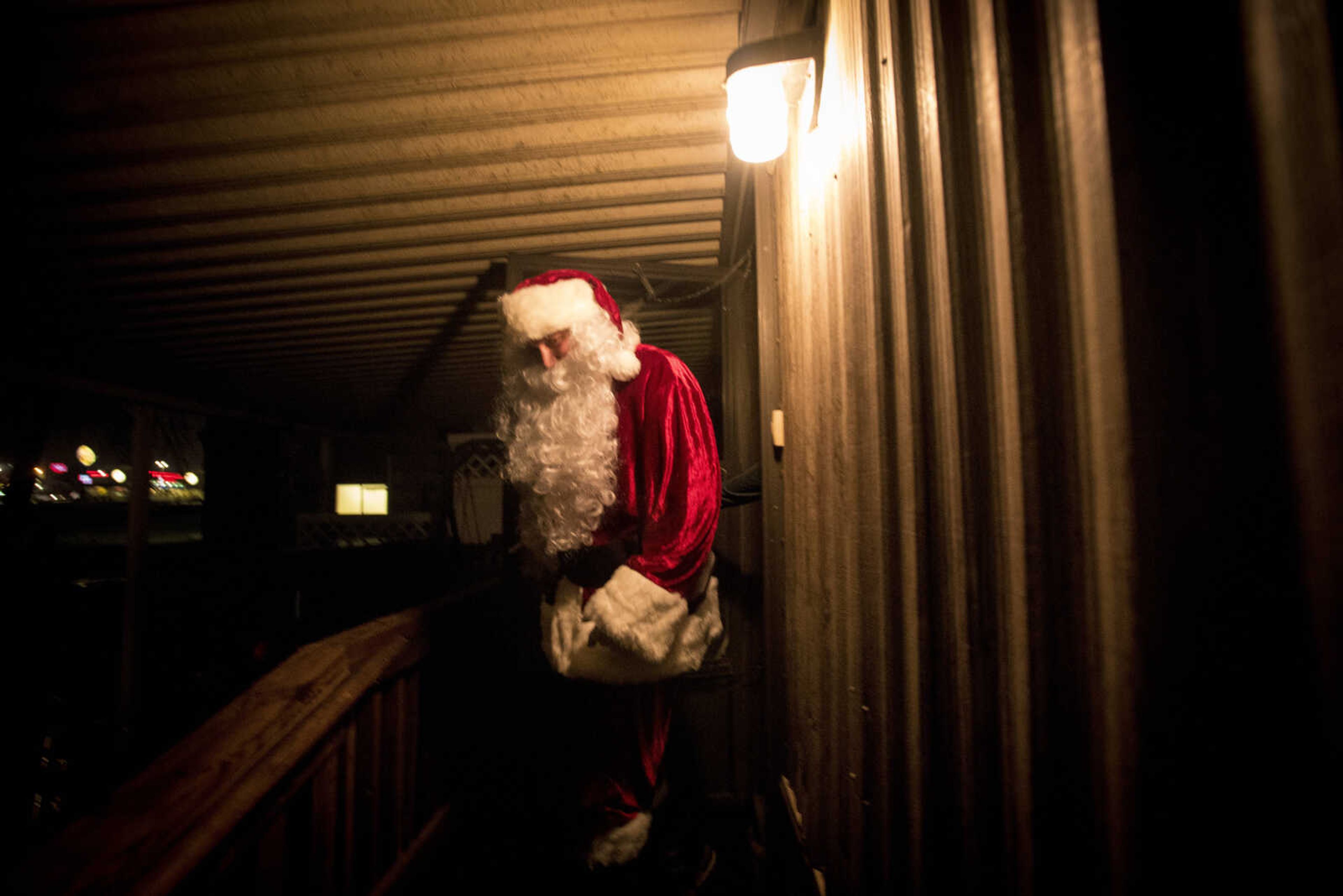 Charlie Wirtle as Santa deliveries presents to kids during the Jaycee Toybox delivery on Thursday, Dec. 22, 2016, in Cape Girardeau.