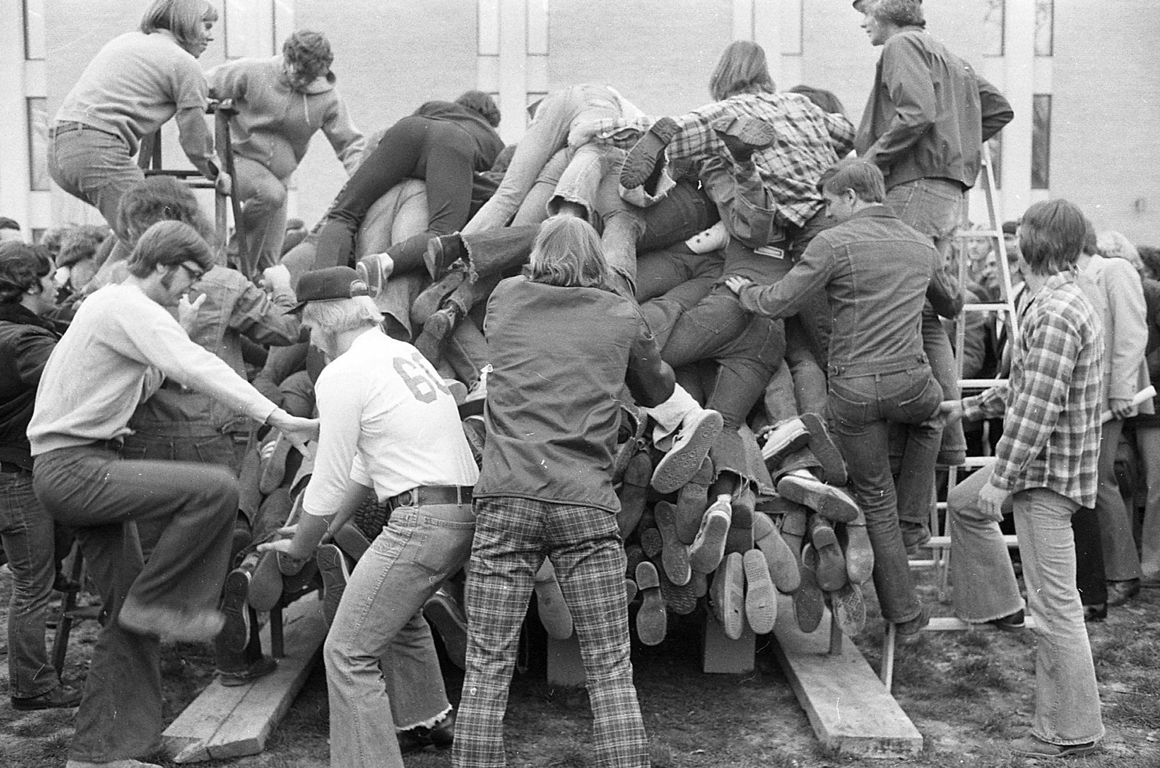 Myers Hall men are crammed on a dorm bed from the two ladders on the side as they break the world's record.