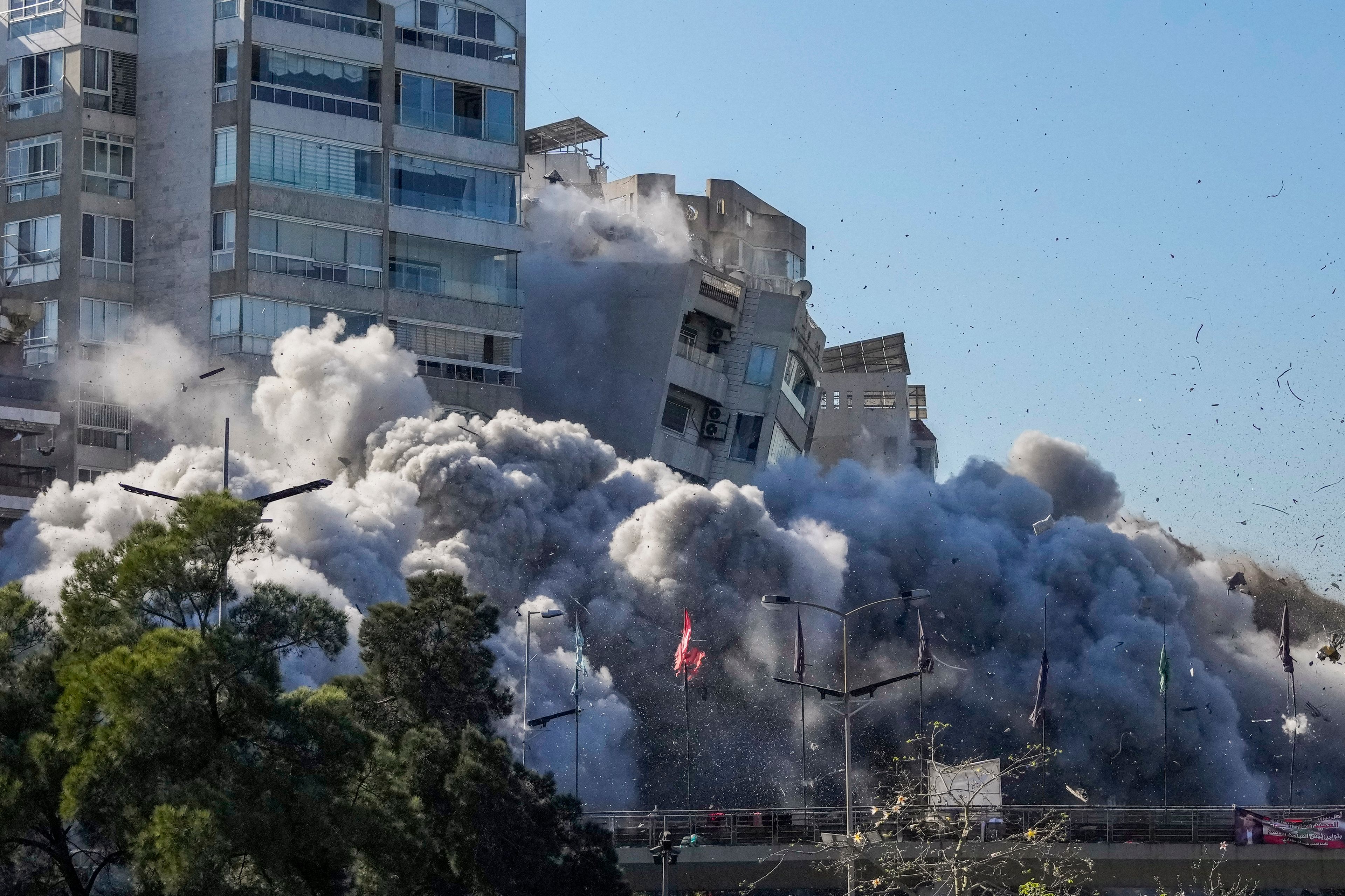 Smoke covers a building that collapses following an Israeli airstrike in Tayouneh, Beirut, Lebanon, Friday, Nov. 15, 2024. (AP Photo/Hassan Ammar)