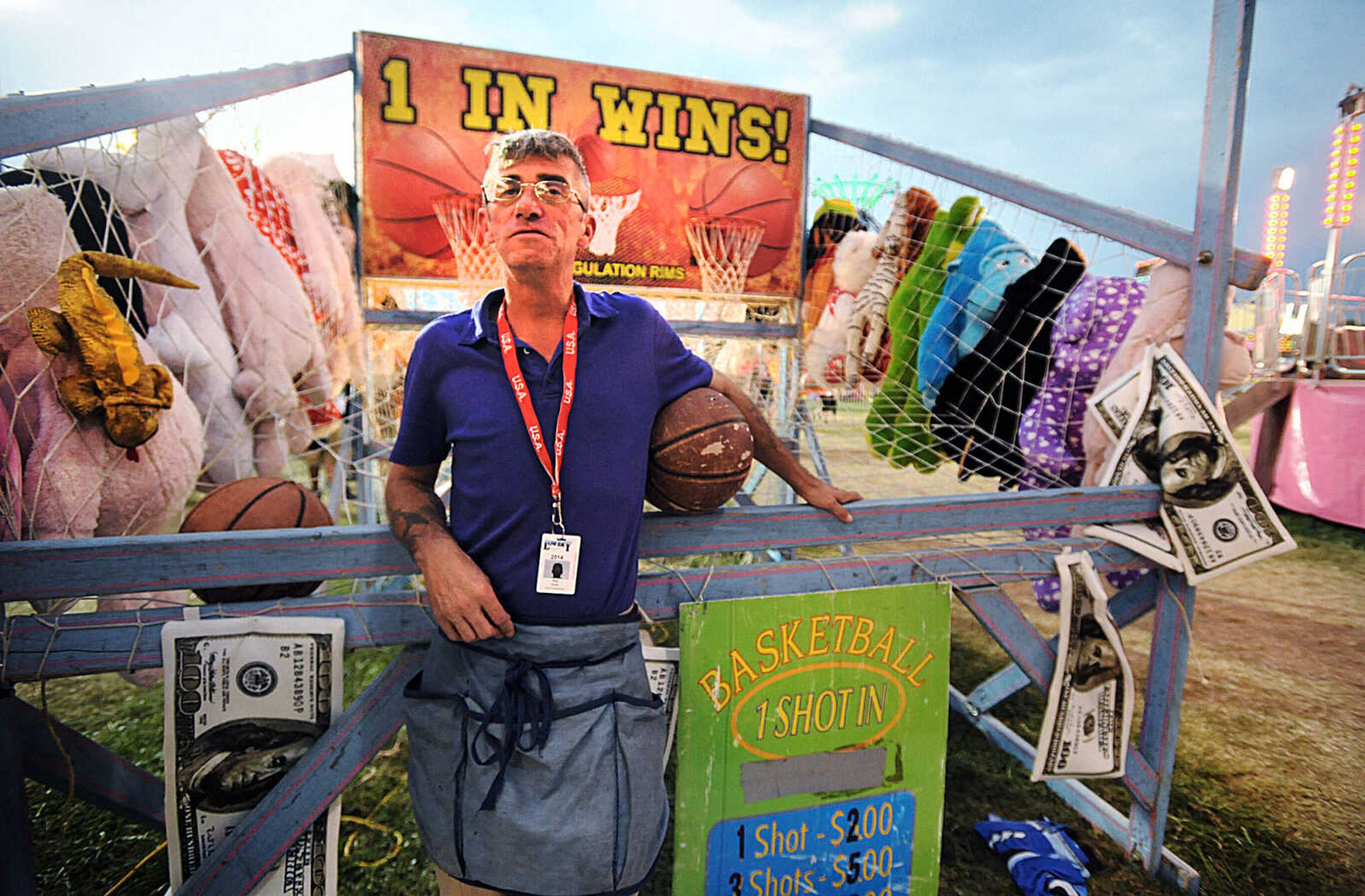 LAURA SIMON ~ lsimon@semissourian.com

Nile Hunt waits for his next contestant at the 1 In Wins basketball game at the SEMO District Fair, Wednesday, Sept. 10, 2014.