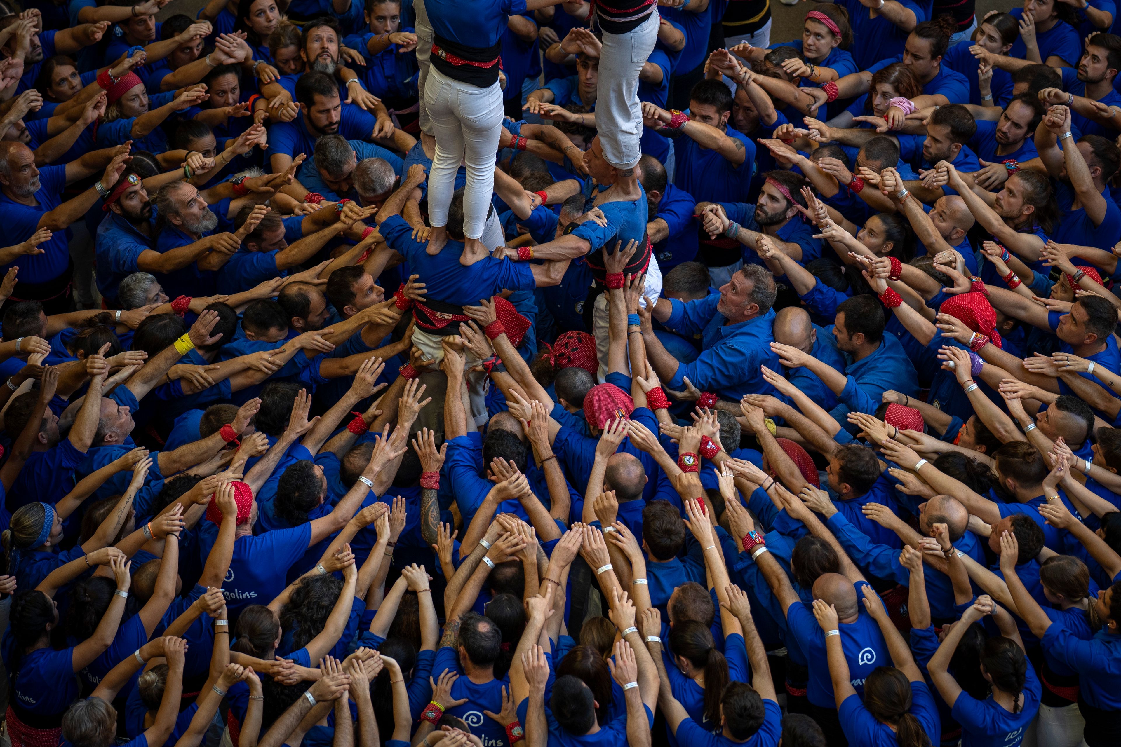 Members of "Castellers de la Vila de Gracia" form a "Castell" or human tower, during the 29th Human Tower Competition in Tarragona, Spain, Saturday, Oct. 5, 2024. (AP Photo/Emilio Morenatti)