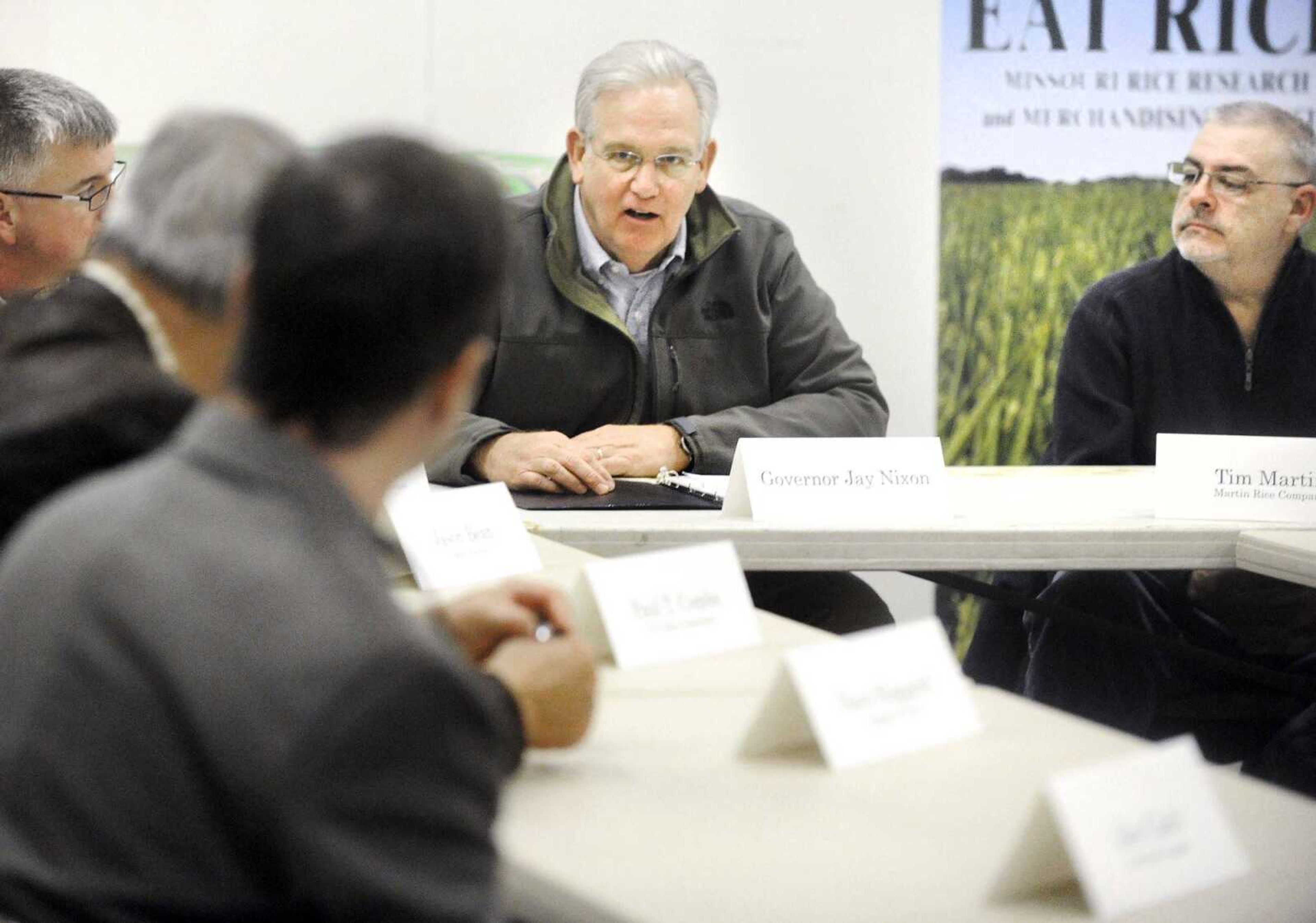 Tim Martin, right, listens as Gov. Jay Nixon, center, speaks during a roundtable discussion Feb. 13 with Missouri farmers at Martin Rice Farm in Bernie, Missouri. The discussion focused on exporting rice to Cuba. (Laura Simon)