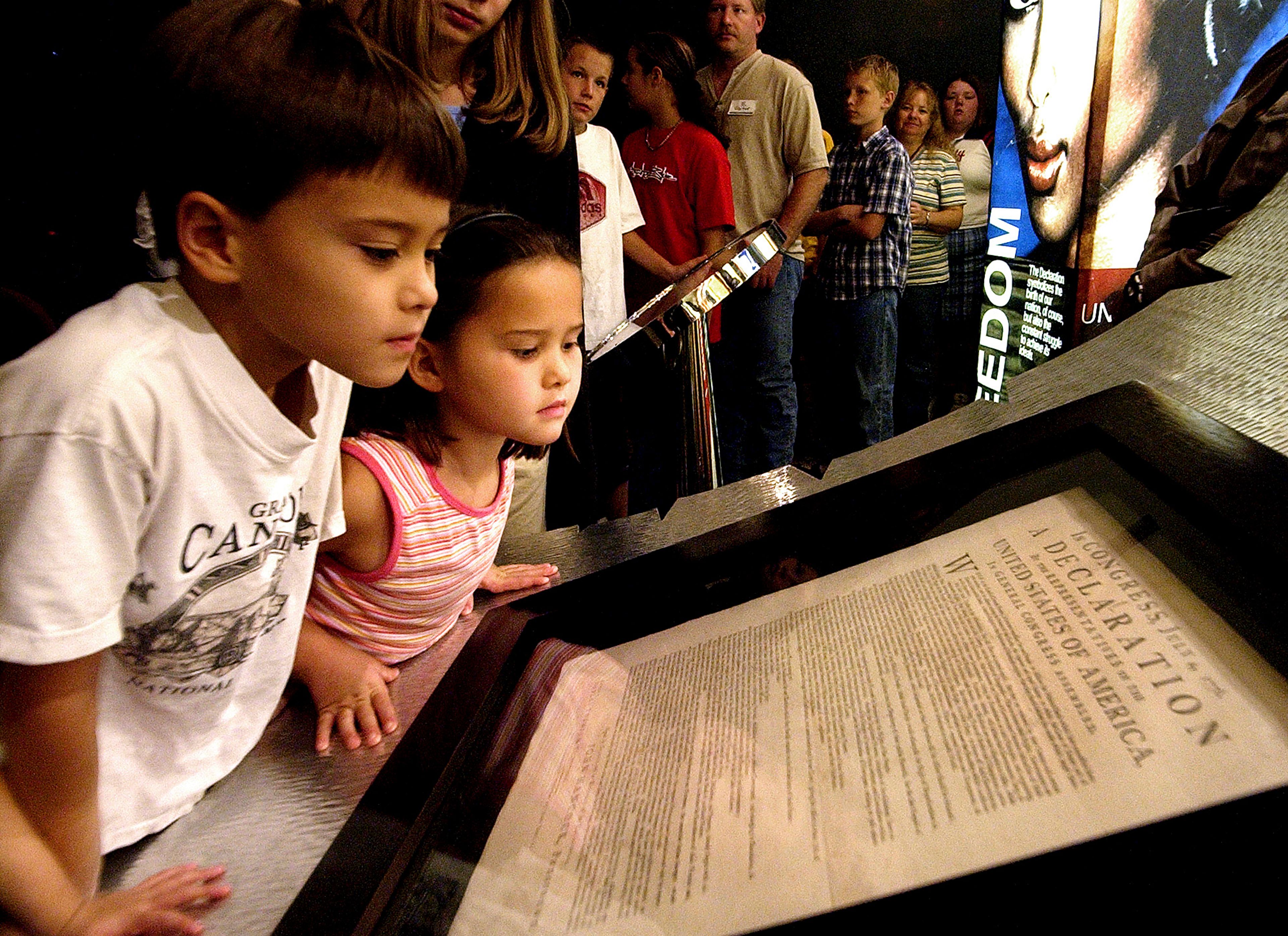 FILE - Conor Park, 8, and his sister Ripley Park, 7, look at an original printed version of the Declaration of Independence at the Capitol in Phoenix, Wednesday, Oct. 8, 2003. (AP Photo/Matt York, File)