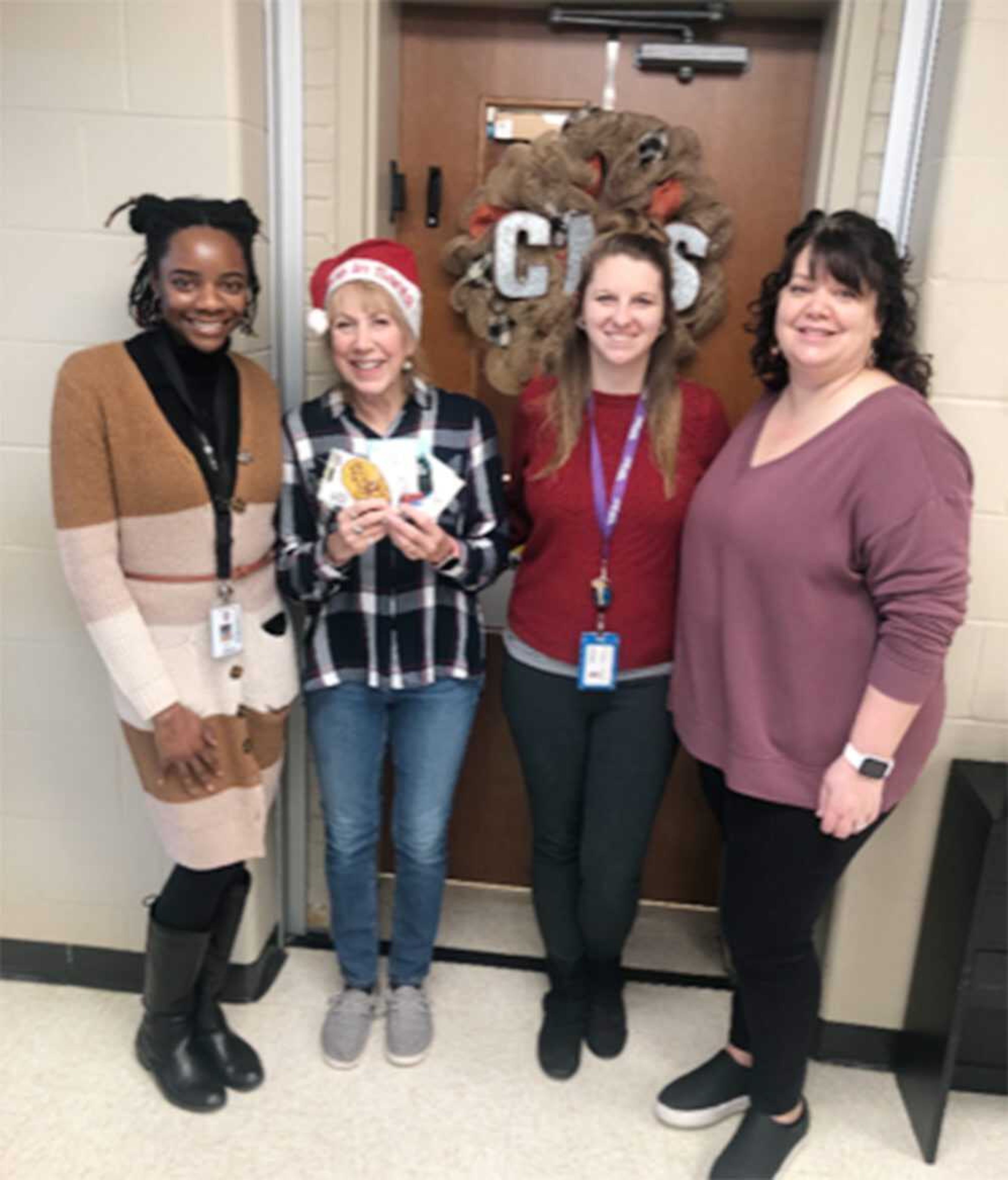 VFW Post 3838 Auxiliary, Daughters of the American Revolution Nancy Hunter Chapter and the Marine Corps League Auxiliary contributed gift cards to help families at Cape Girardeau Middle School enjoy a Cracker Barrel meal for Christmas. Pictured, from left, are Tiffany Mead, Tiger Lily mentor; Dale Humphries, representing the three organizations; Samantha Gross, social worker; and Becky Wright, assistant principal.